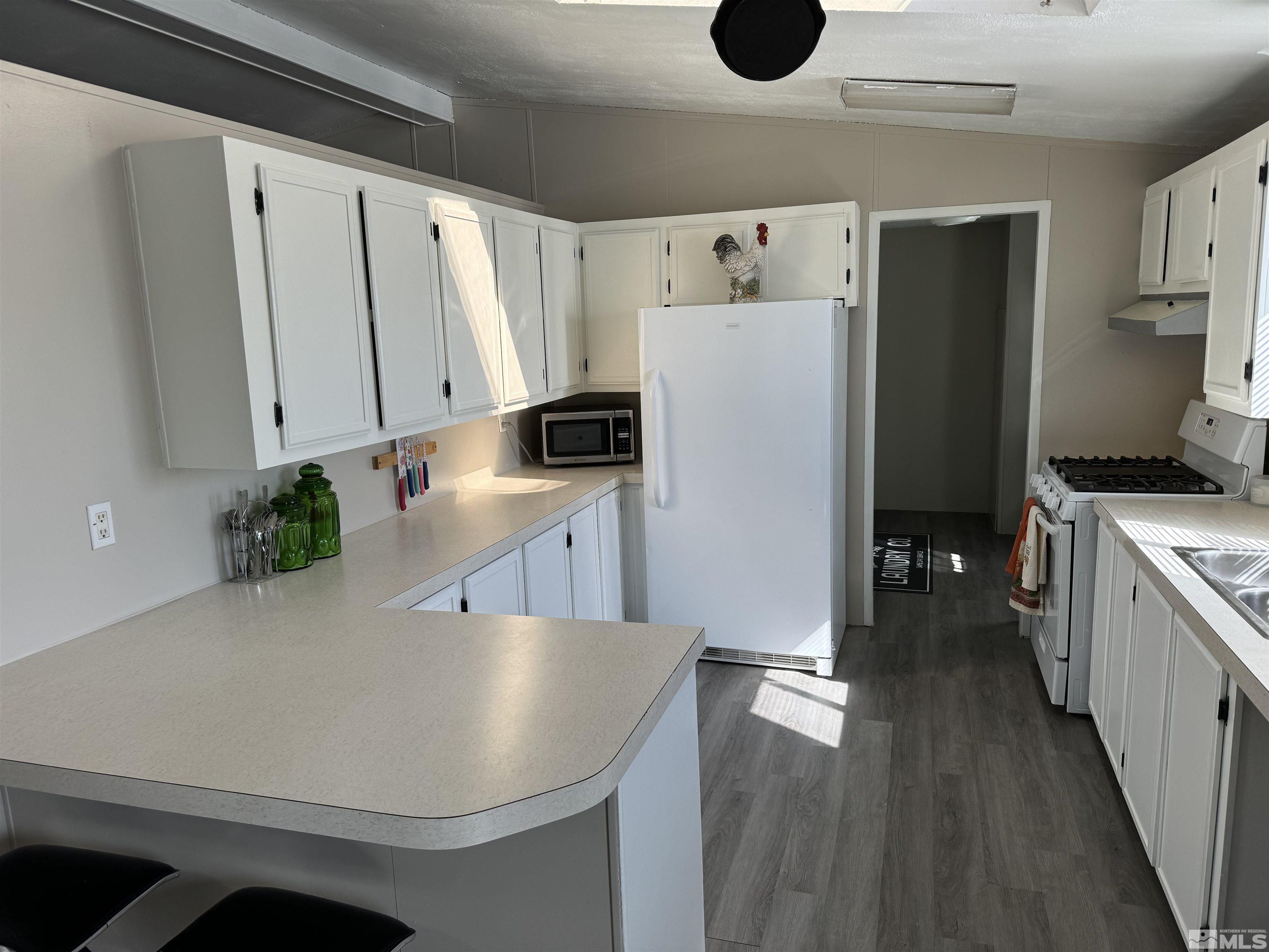 5500 Mission Road Fallon, NV 89406 - Photo 4 of 15 a kitchen with stainless steel appliances a refrigerator sink and white cabinets