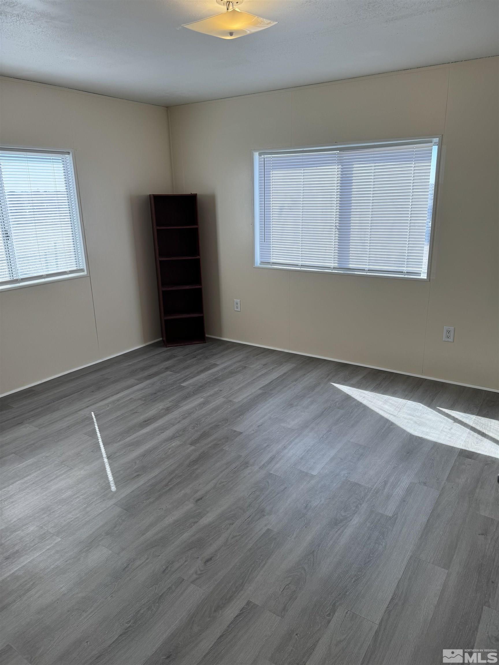 5500 Mission Road Fallon, NV 89406 - Photo 9 of 15 a view of an empty room with wooden floor and a window