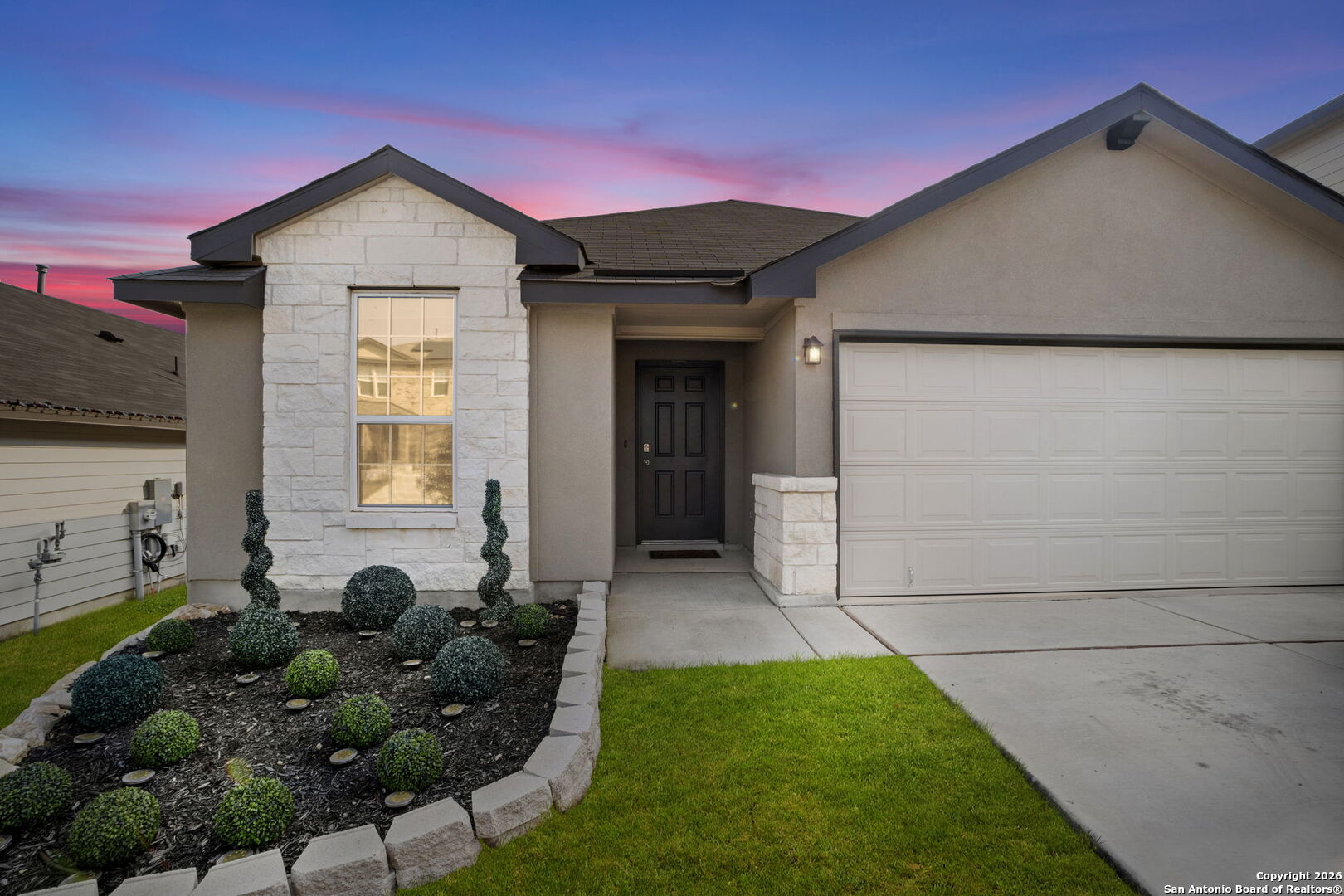 a front view of a house with a yard