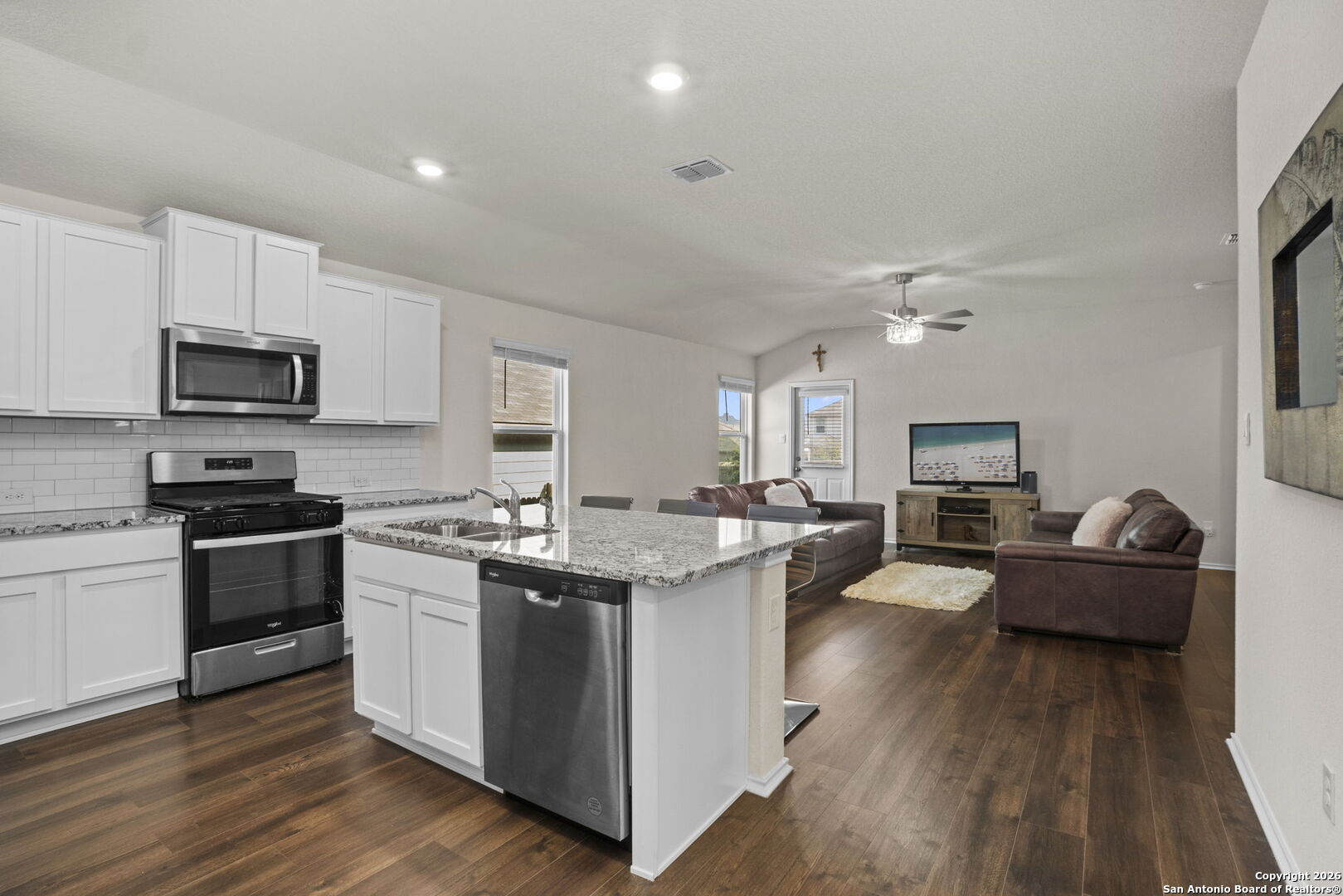 3658 Copper Willow Bulverde, TX 78163 - Photo 12 of 27 a kitchen with stainless steel appliances kitchen island granite countertop a stove top oven a sink a counter space and cabinets