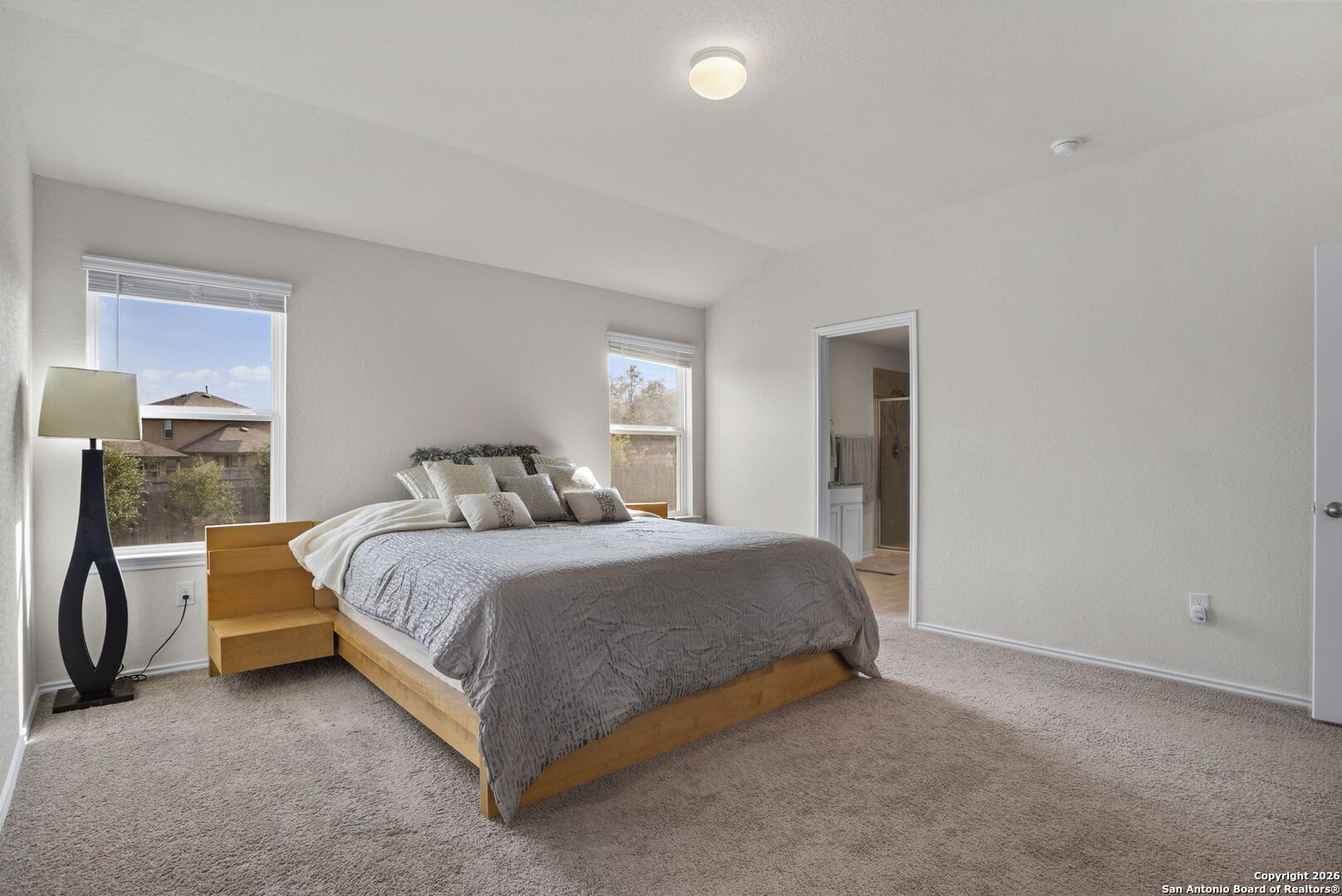 3658 Copper Willow Bulverde, TX 78163 - Photo 18 of 27 a bedroom with a bed lamp and a fireplace