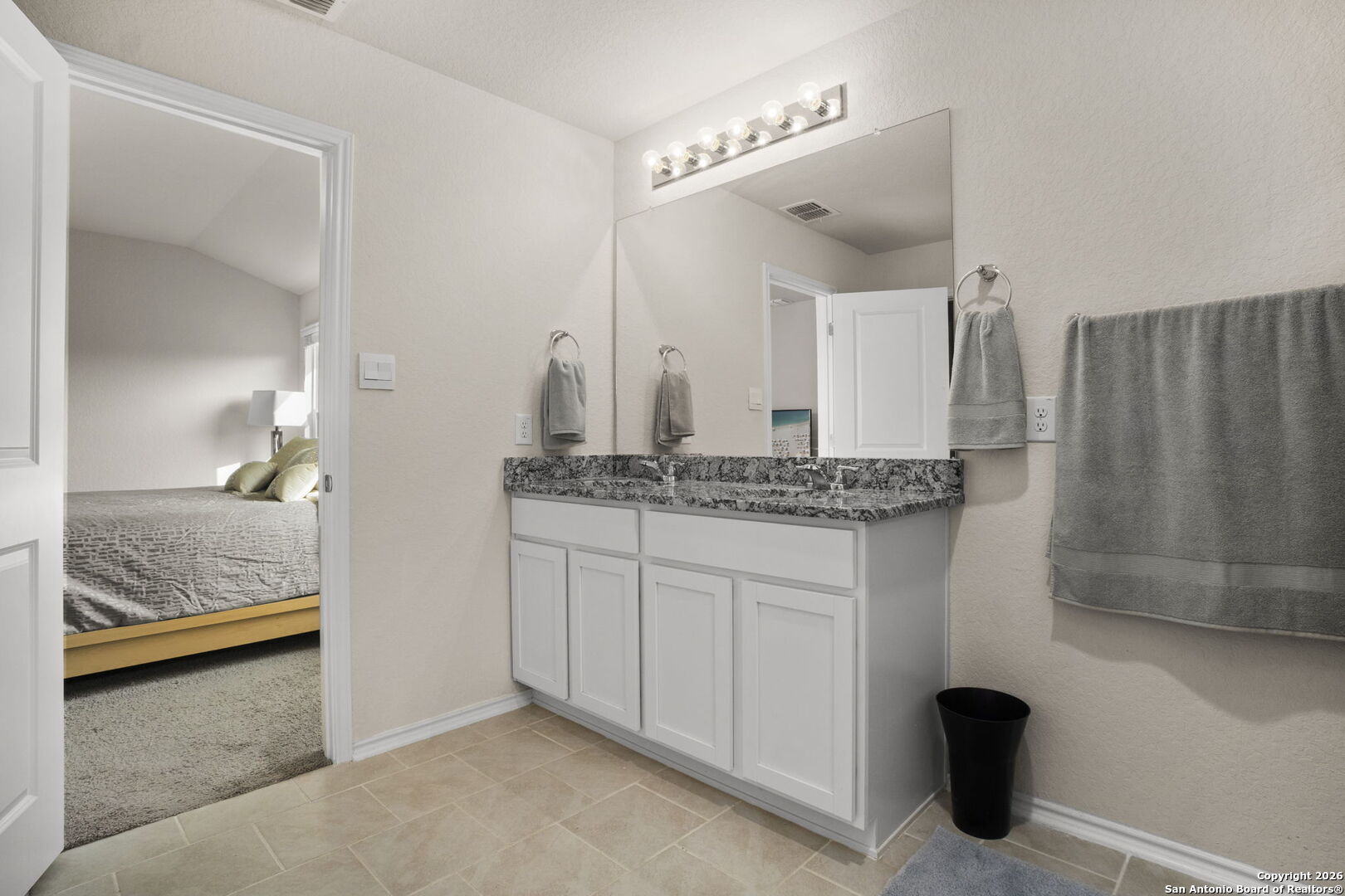 3658 Copper Willow Bulverde, TX 78163 - Photo 19 of 27 a en suite bathroom with a granite countertop sink and a mirror