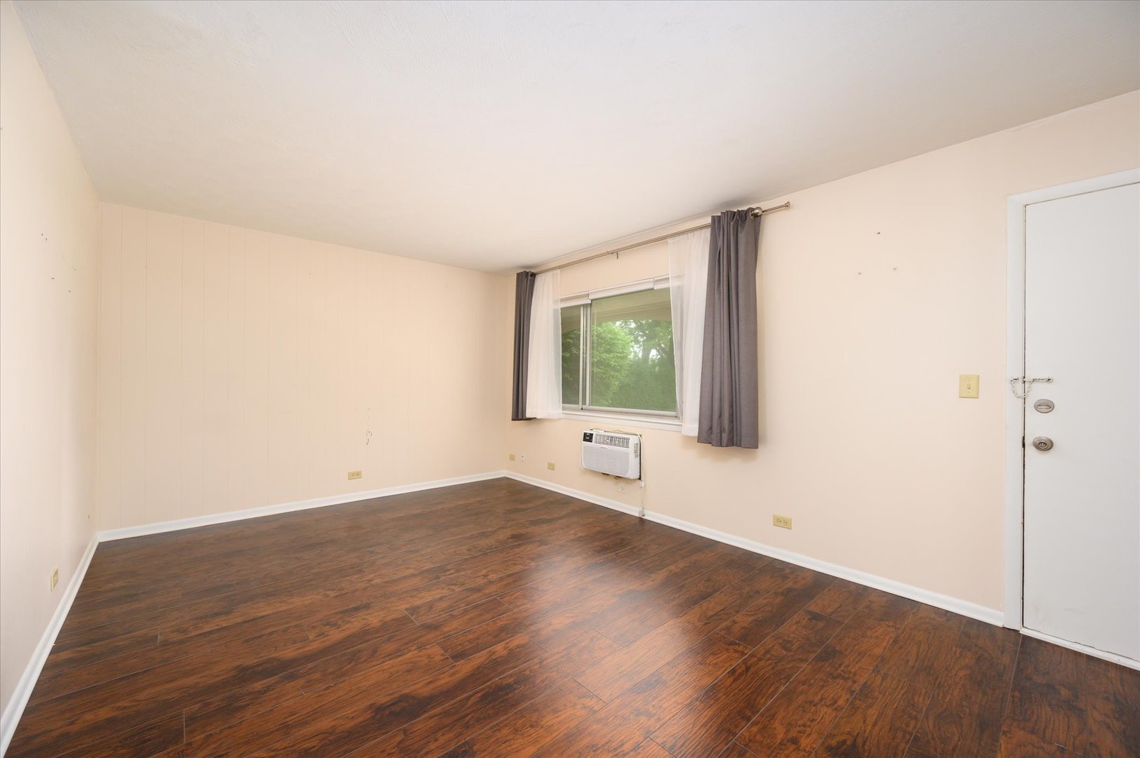 235 East Palatine Road, Unit 1C Palatine, IL 60067 - Photo 3 of 13 an empty room with wooden floor and windows