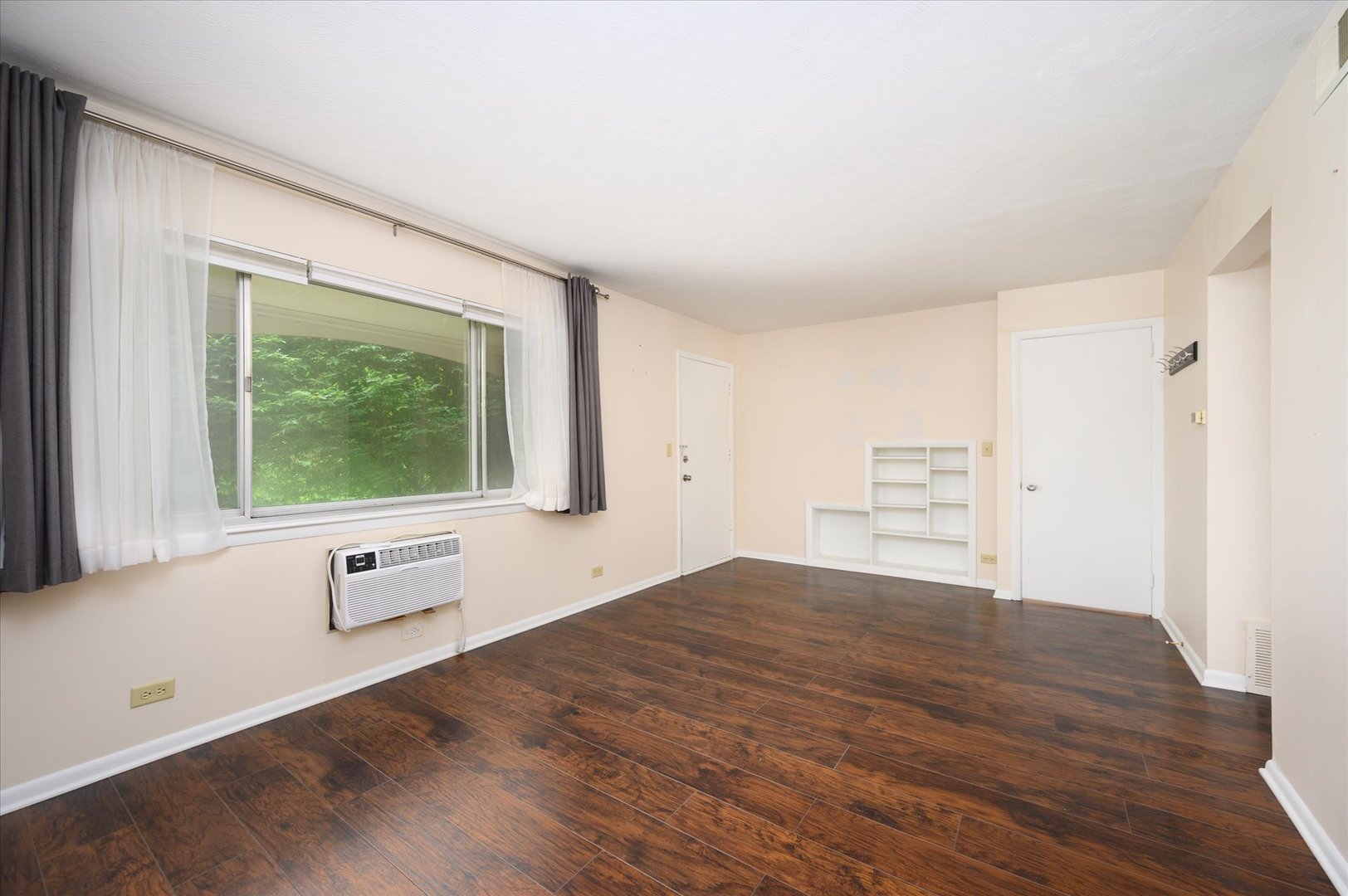 235 East Palatine Road, Unit 1C Palatine, IL 60067 - Photo 5 of 13 a view of empty room with wooden floor and fan