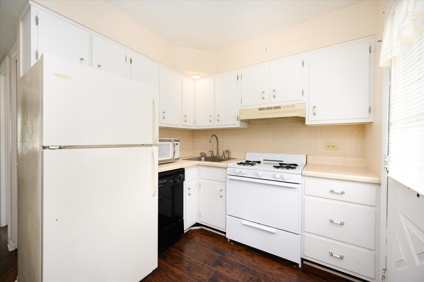 235 East Palatine Road, Unit 1C Palatine, IL 60067 - Photo 6 of 13 a kitchen with a white cabinets and white appliances