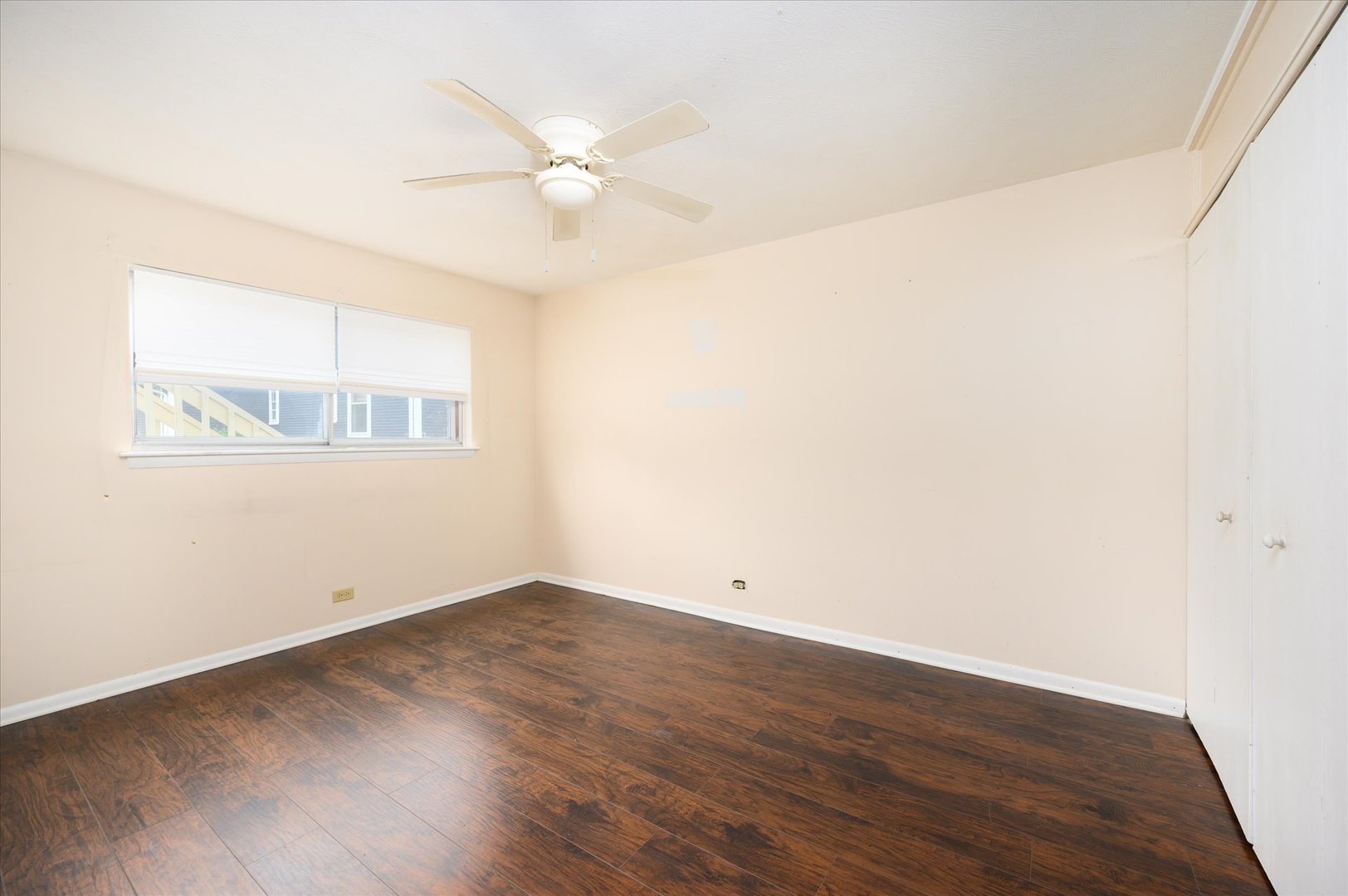 235 East Palatine Road, Unit 1C Palatine, IL 60067 - Photo 8 of 13 an empty room with wooden floor and windows