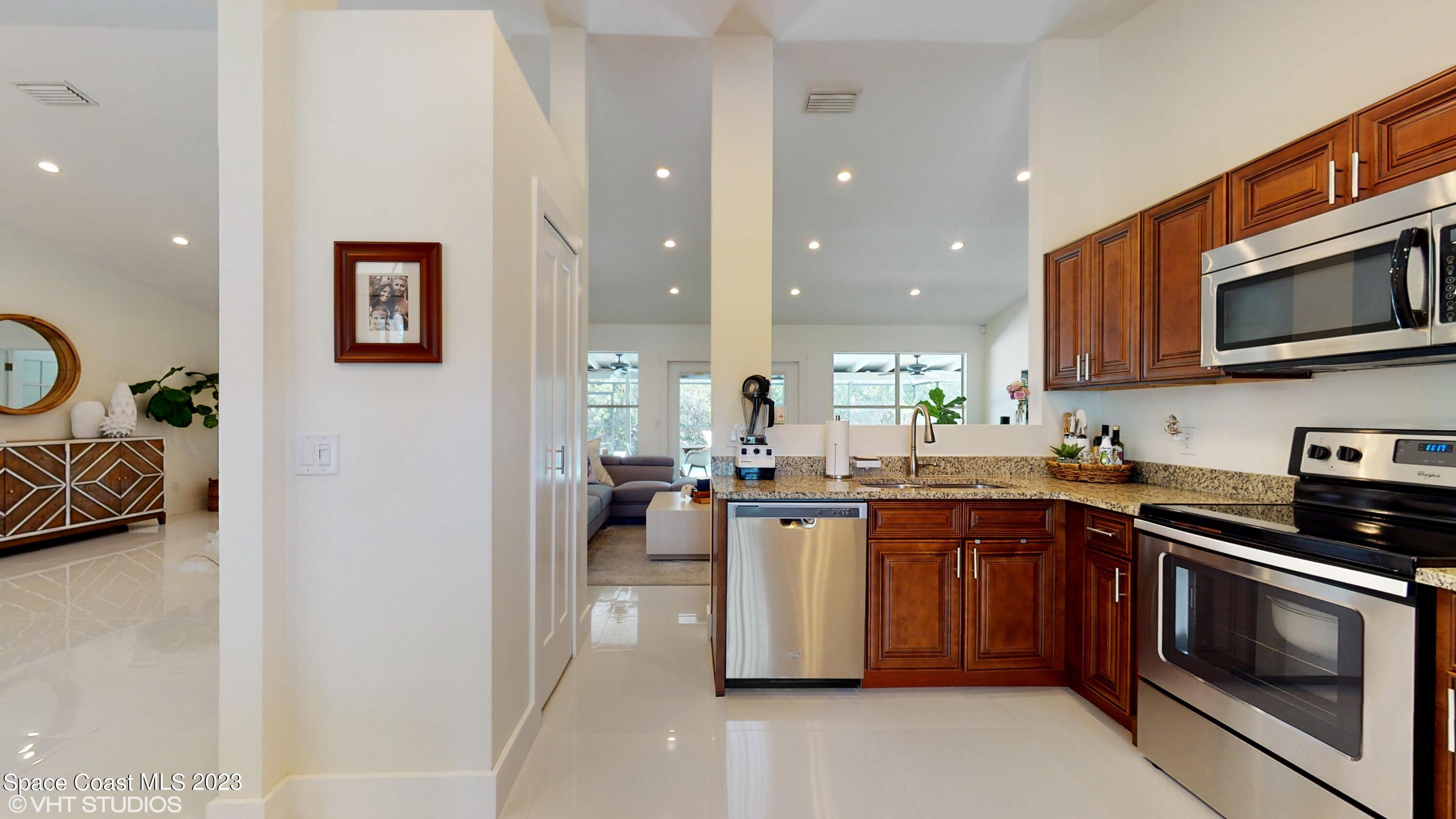 1650 Benjamin Road Malabar, FL 32950 - Photo 13 of 34 a kitchen with a sink cabinets and stainless steel appliances