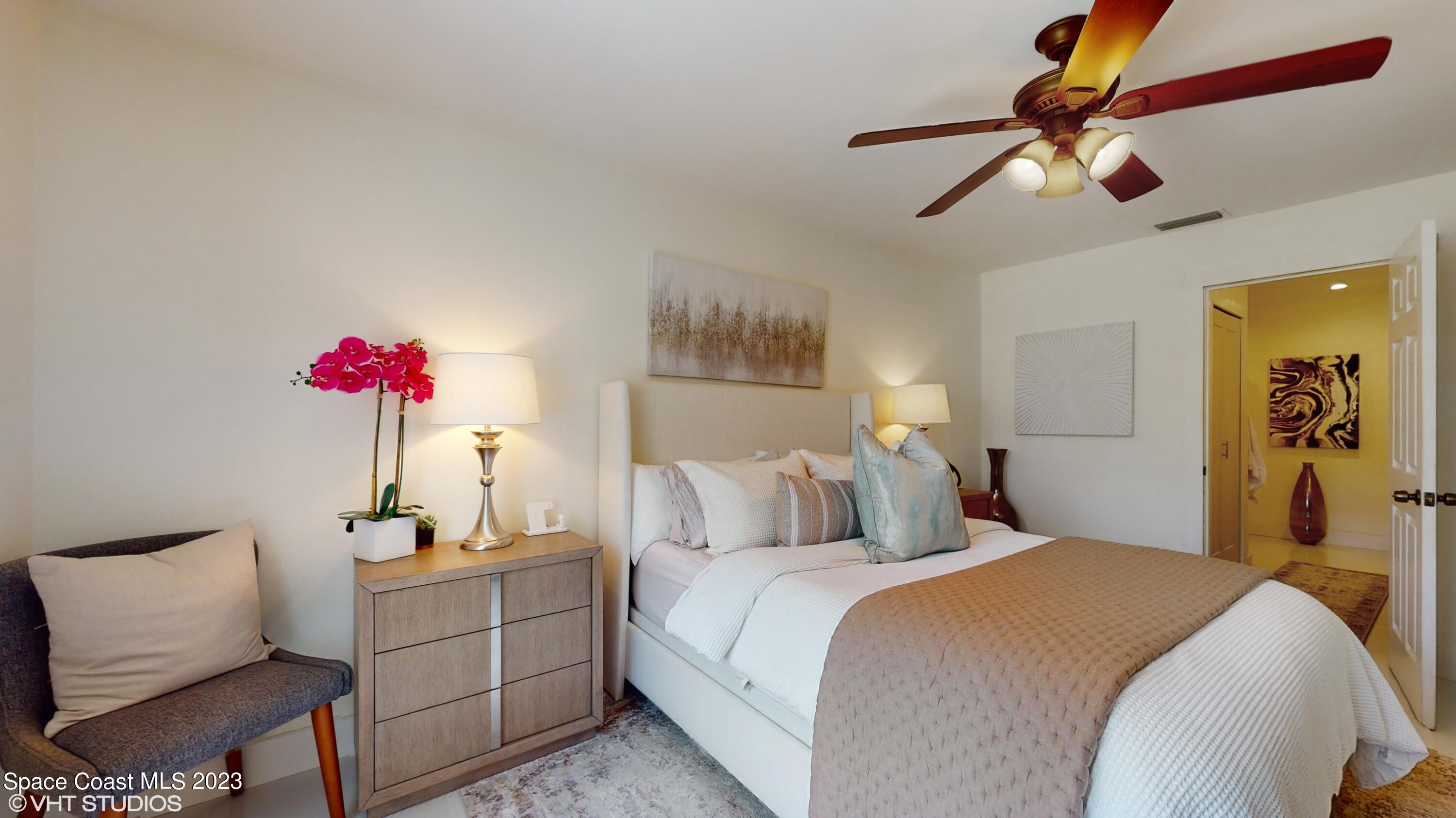 1650 Benjamin Road Malabar, FL 32950 - Photo 19 of 34 a bedroom with a bed and a chandelier