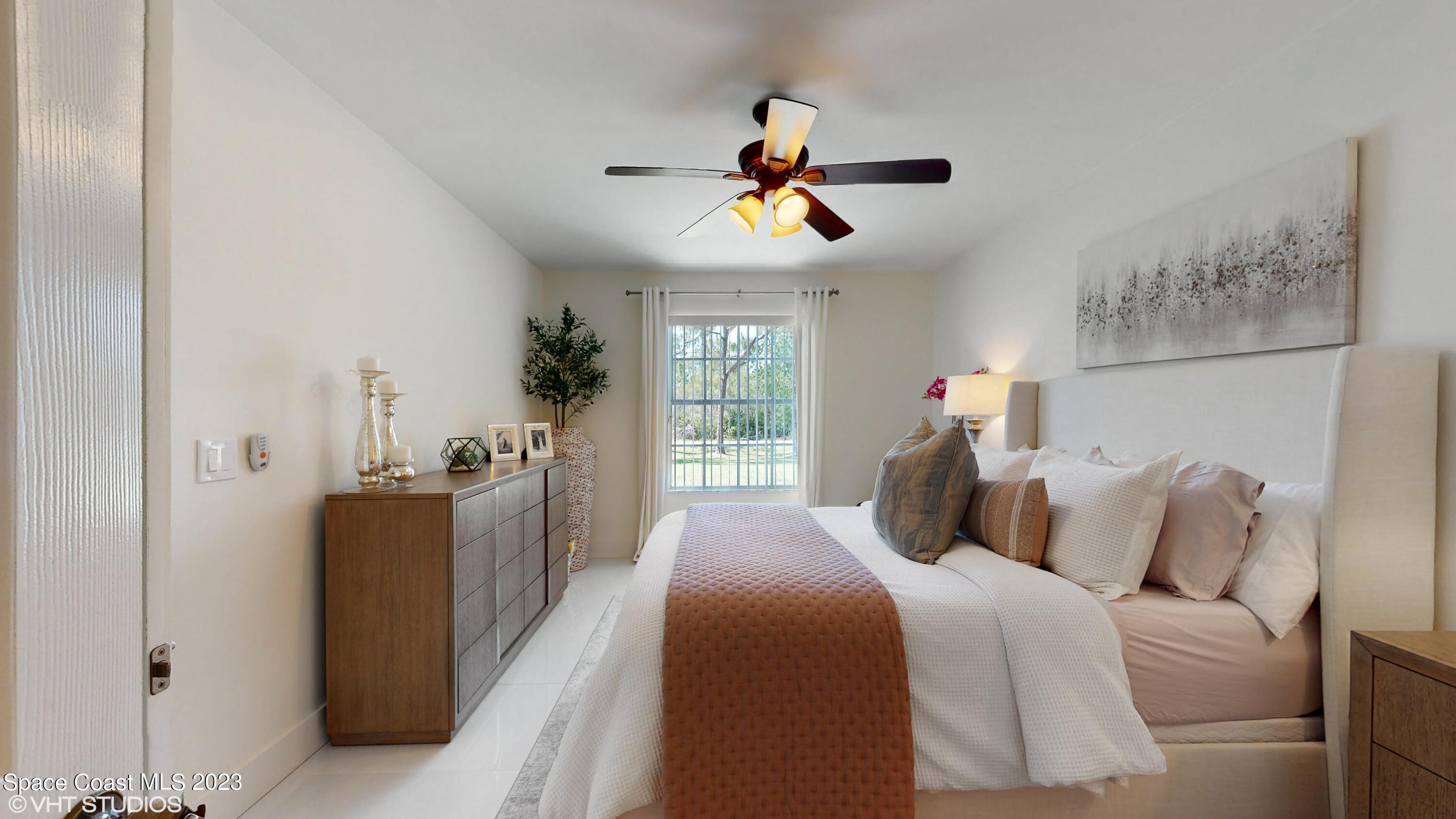 1650 Benjamin Road Malabar, FL 32950 - Photo 20 of 34 a bedroom with a bed and a chandelier