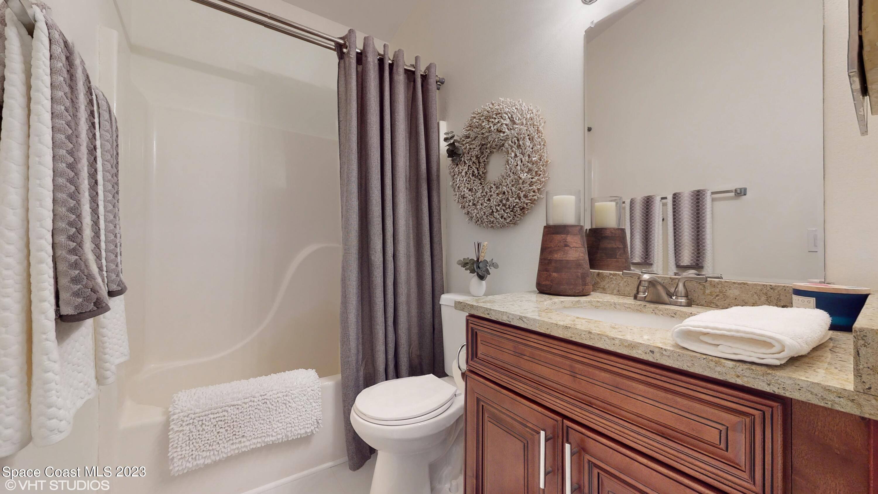 1650 Benjamin Road Malabar, FL 32950 - Photo 25 of 34 a bathroom with a granite countertop sink toilet and shower