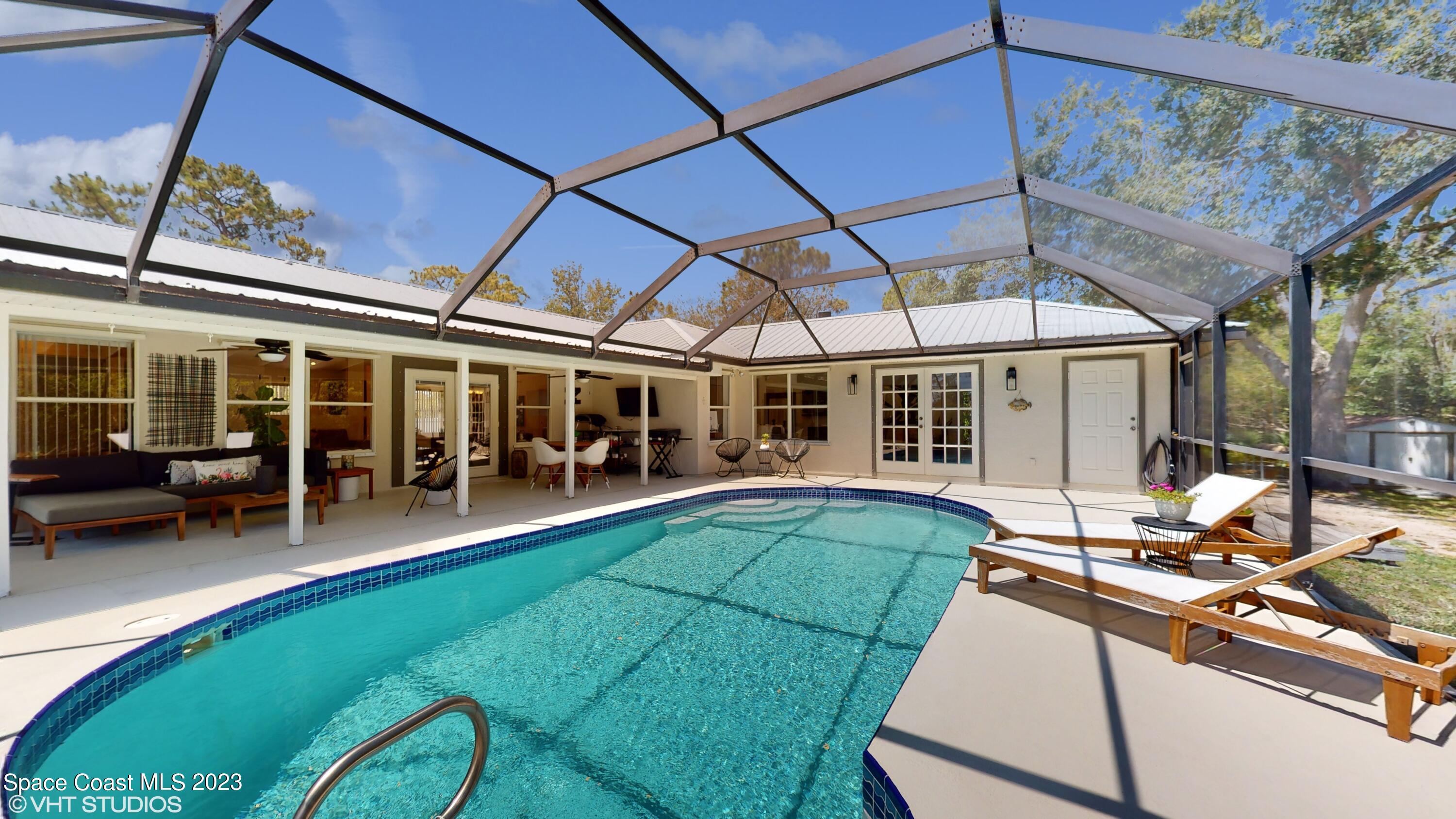 1650 Benjamin Road Malabar, FL 32950 - Photo 28 of 34 a view of a house with backyard porch and sitting area