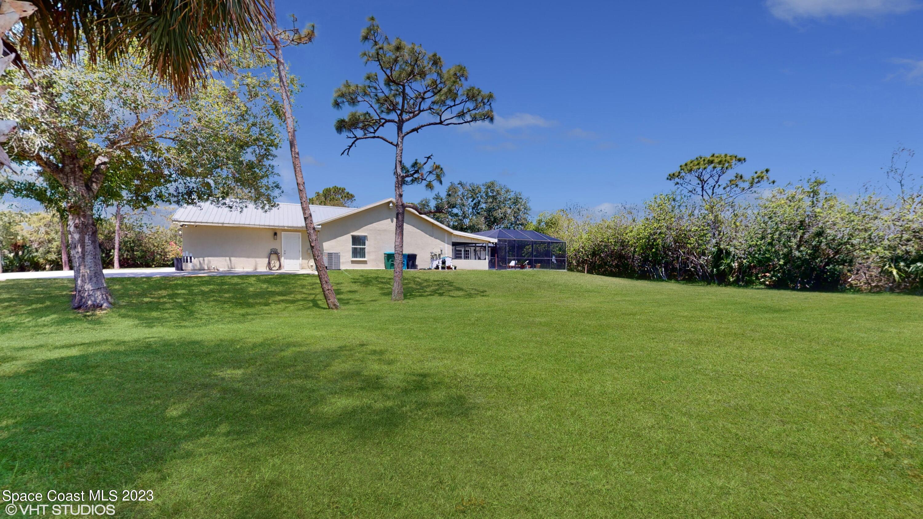1650 Benjamin Road Malabar, FL 32950 - Photo 32 of 34 a view of a house with a yard