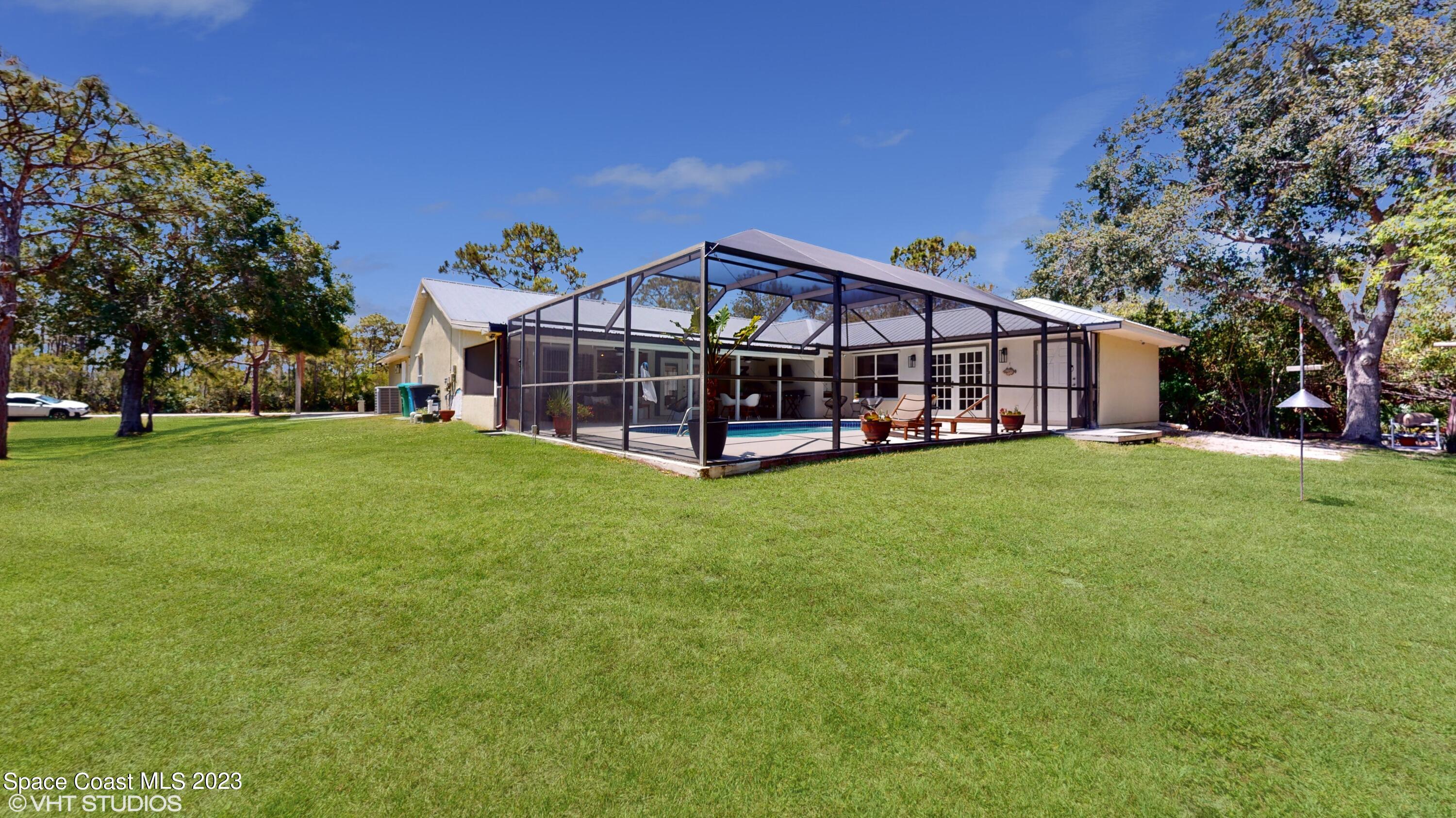1650 Benjamin Road Malabar, FL 32950 - Photo 33 of 34 a view of a house with a yard and sitting area