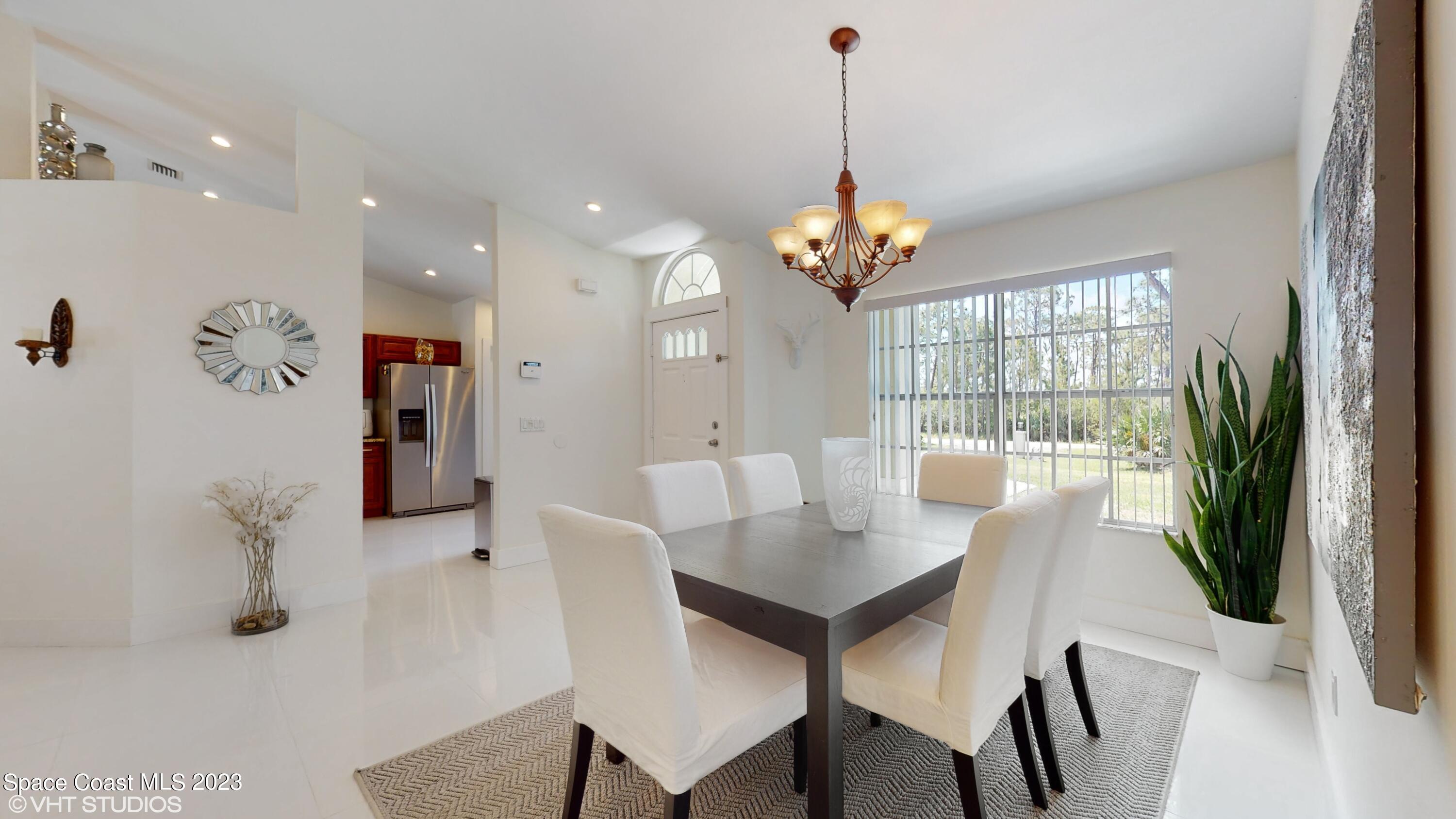 1650 Benjamin Road Malabar, FL 32950 - Photo 10 of 34 a view of a dining room with furniture window and wooden floor