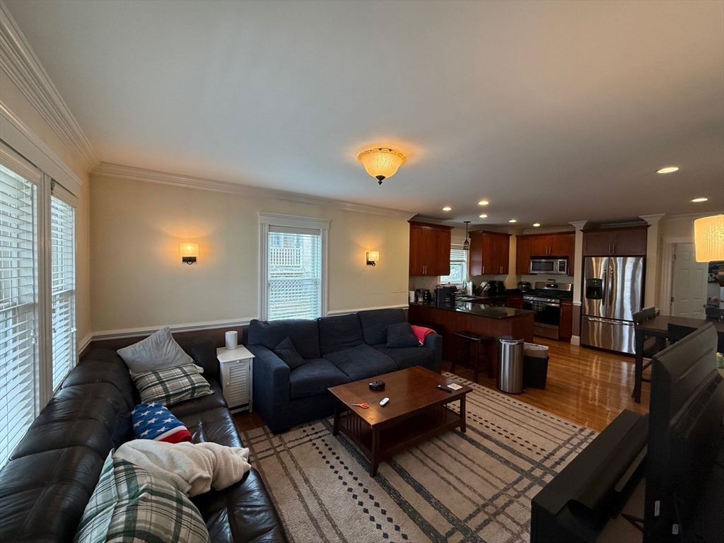 72 Bennett Street, Unit 72 Boston, MA 02135 - Photo 1 of 17 a living room with furniture and kitchen view