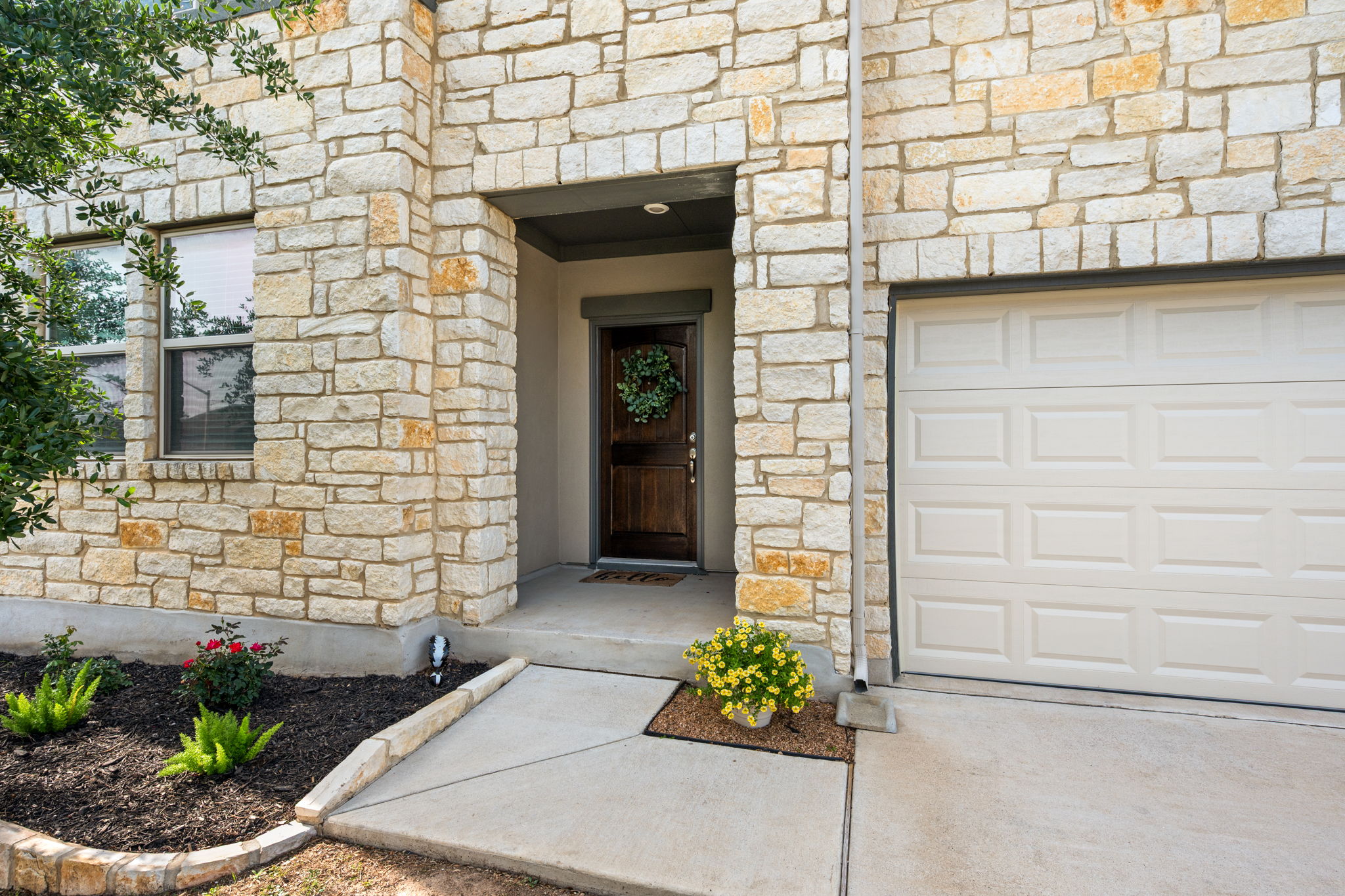 409 Limestone Road Liberty Hill, TX 78642 - Photo 4 of 35 a front view of a house with a garden