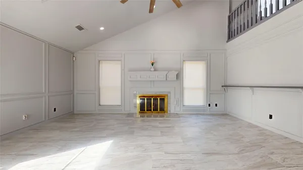 a view of a hallway with wooden floor and a fireplace