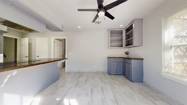a kitchen with granite countertop a sink cabinets and stainless steel appliances