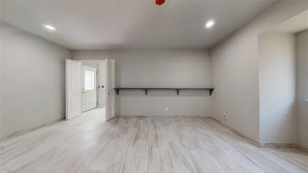 a view of empty room with wooden floor and fireplace
