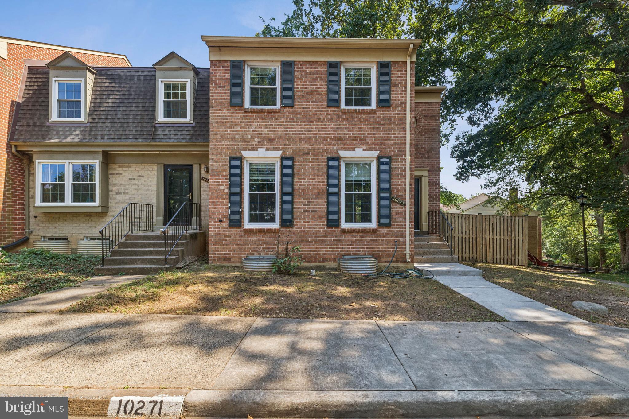 10271 Braddock Road Fairfax, VA 22032 - Photo 1 of 25 a view of a brick house with many windows and a large tree