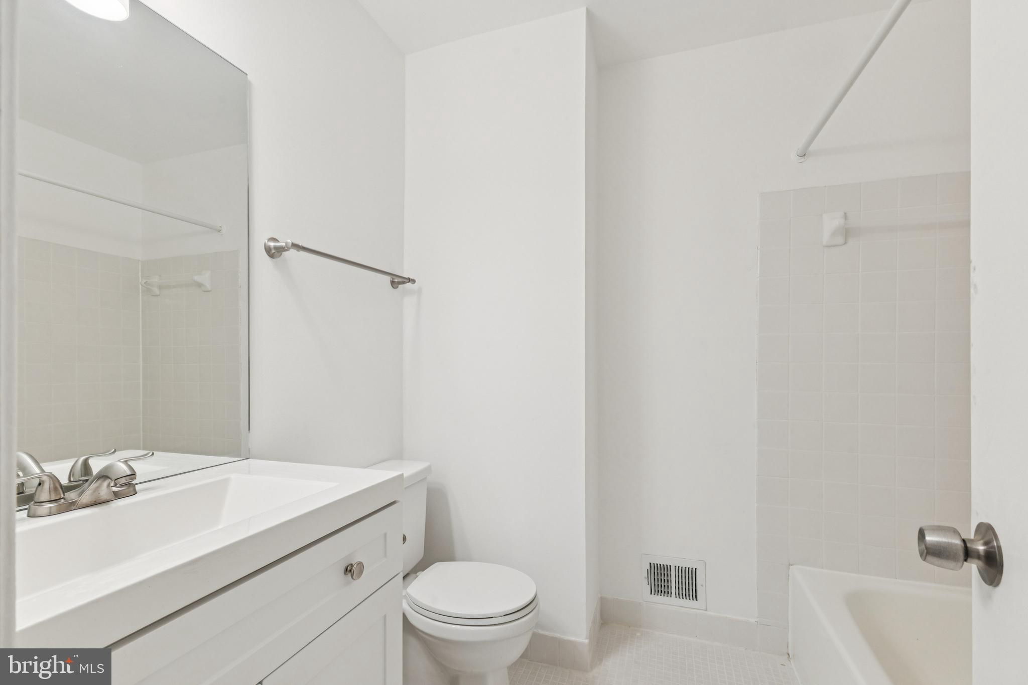 10271 Braddock Road Fairfax, VA 22032 - Photo 19 of 25 a bathroom with a sink toilet vanity and tub