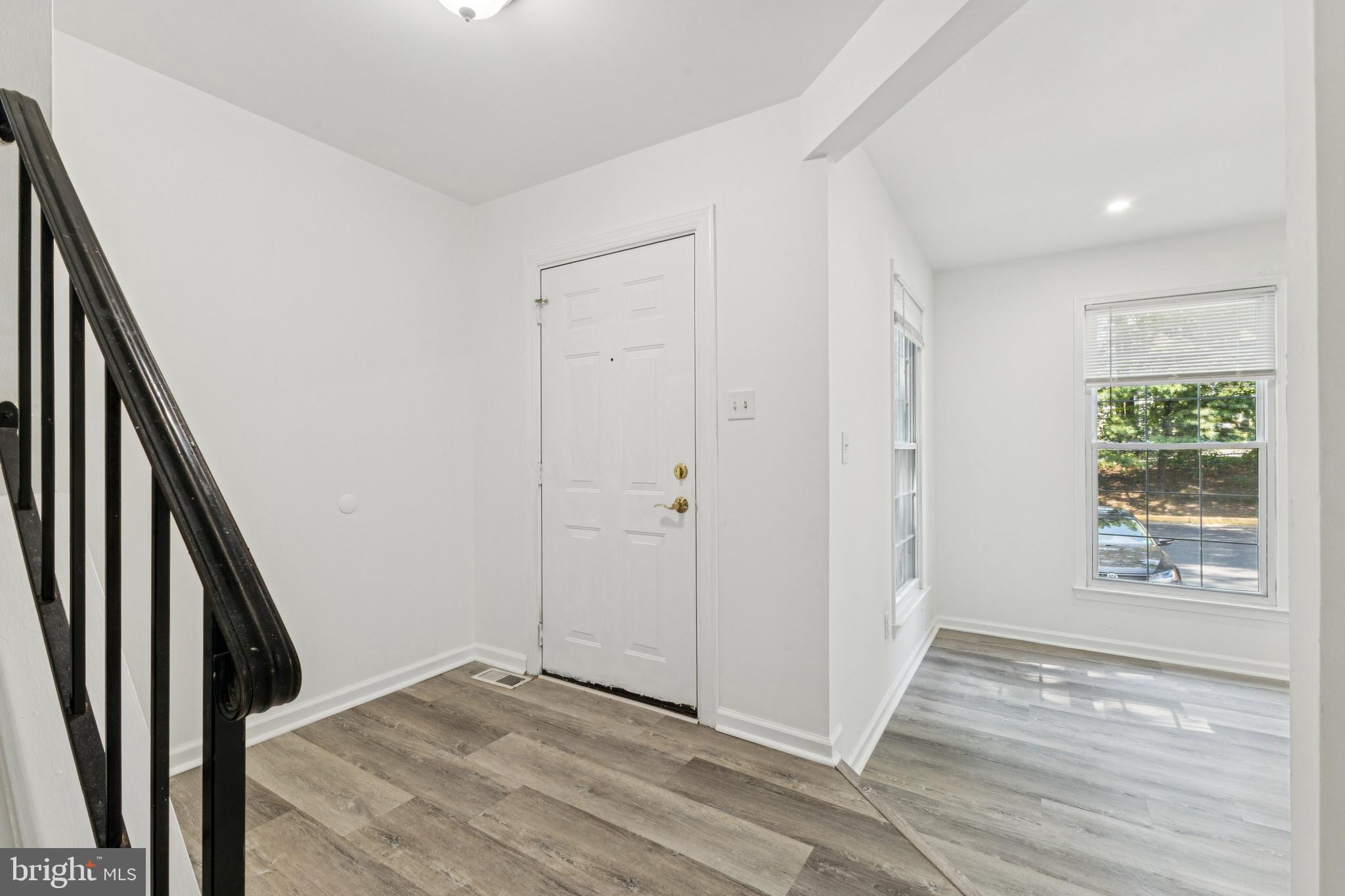 10271 Braddock Road Fairfax, VA 22032 - Photo 3 of 25 a view of an empty room with wooden floor and a window