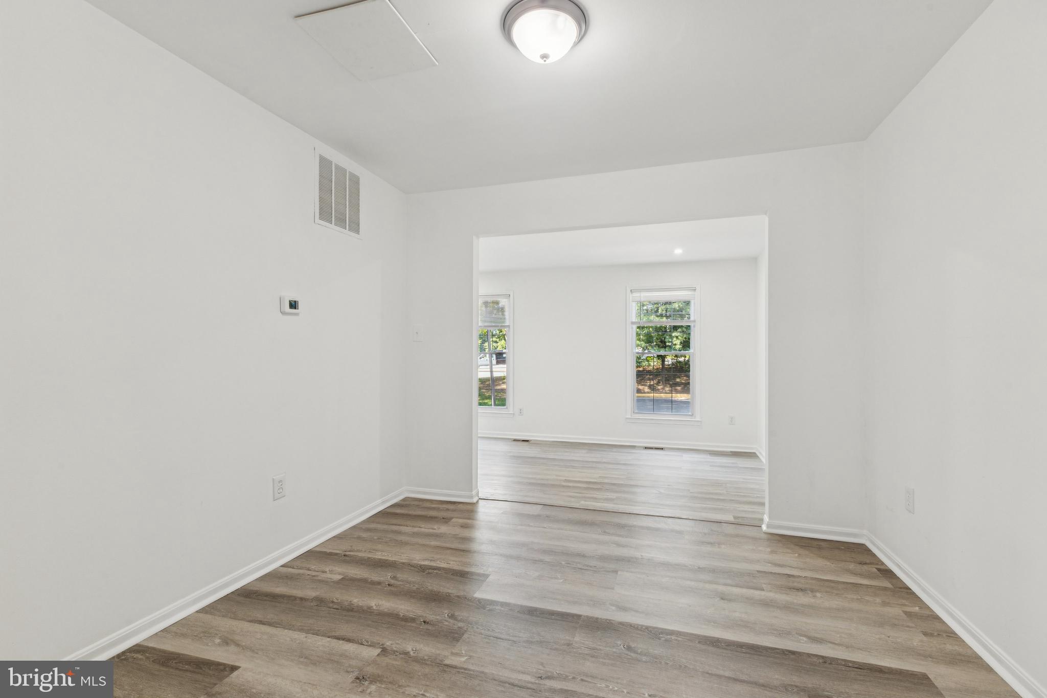 10271 Braddock Road Fairfax, VA 22032 - Photo 9 of 25 an empty room with wooden floor and windows