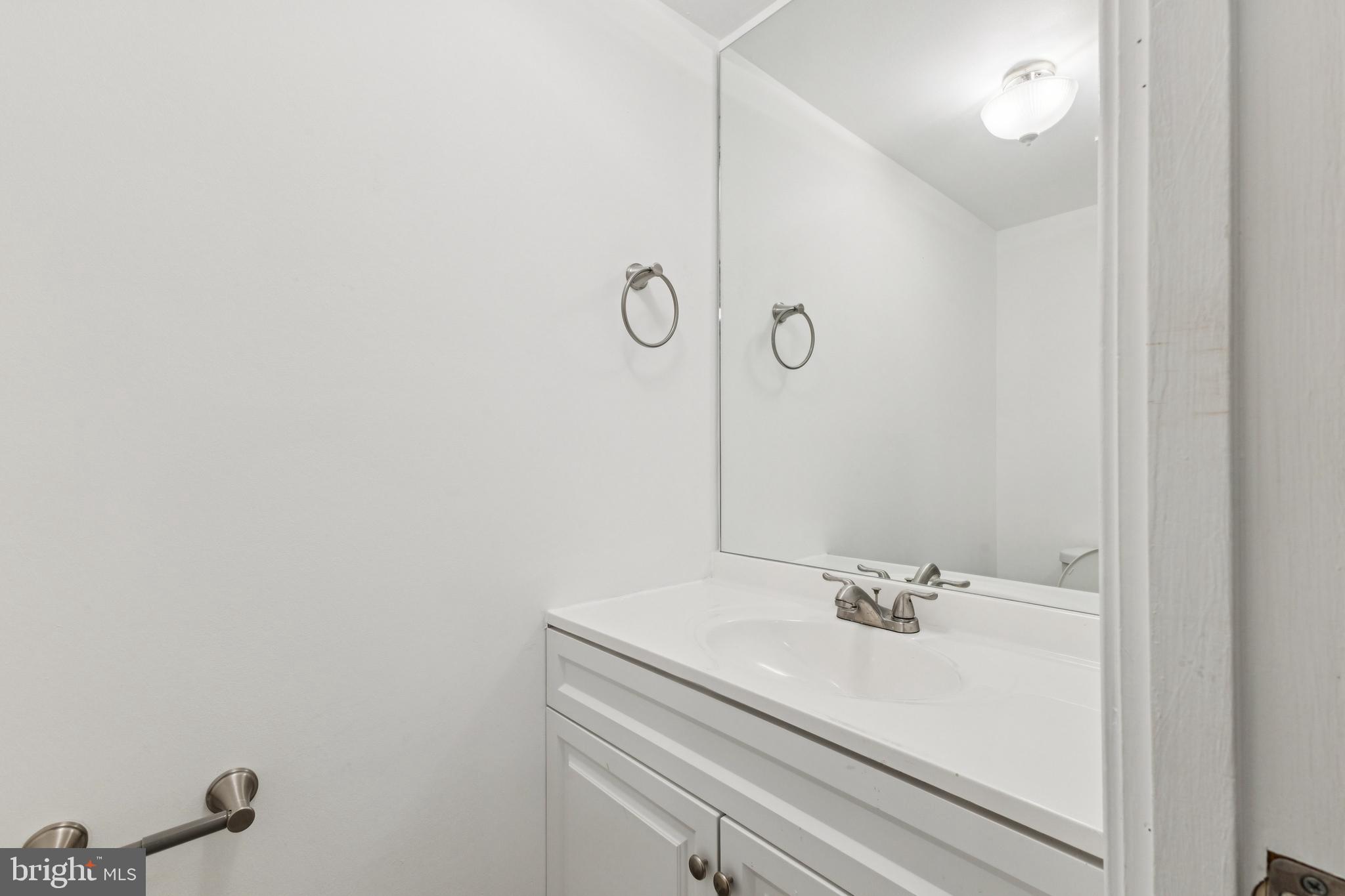 10271 Braddock Road Fairfax, VA 22032 - Photo 10 of 25 a bathroom with a sink and a mirror