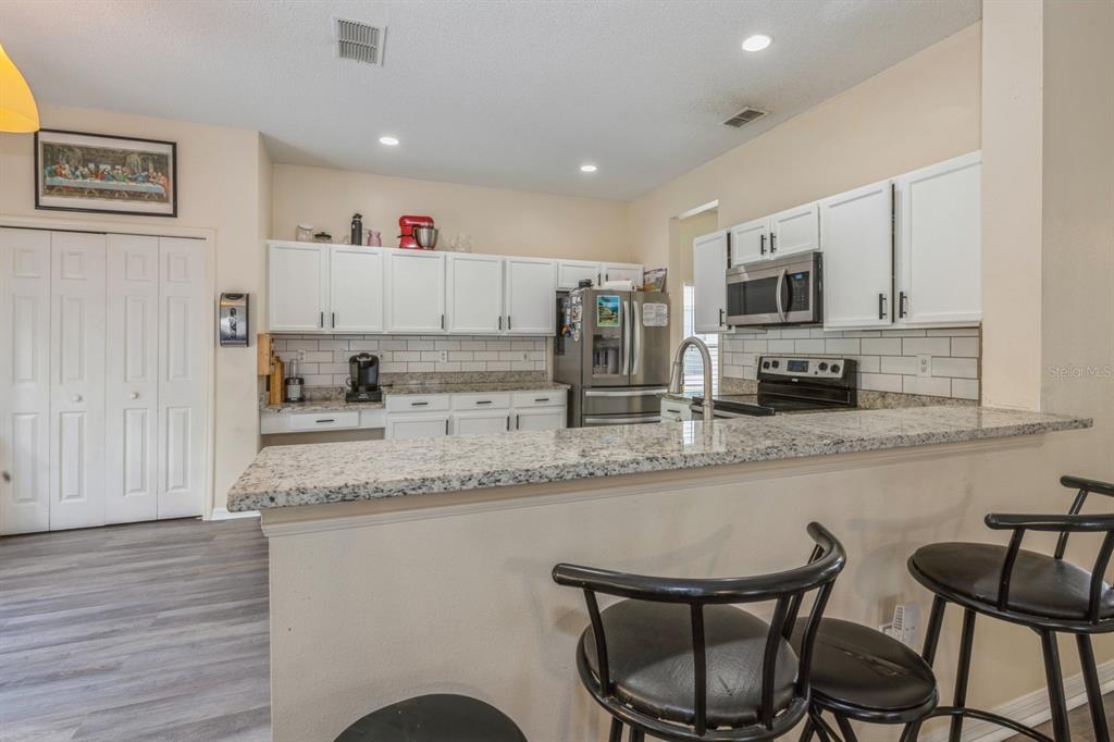 502 Freeman Street Longwood, FL 32750 - Photo 2 of 21 a kitchen with stainless steel appliances granite countertop a sink and cabinets