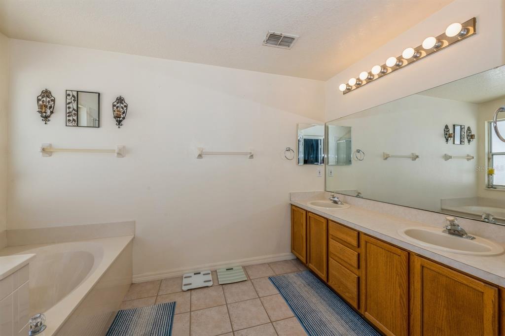 502 Freeman Street Longwood, FL 32750 - Photo 10 of 21 a bathroom with a tub sink and mirror