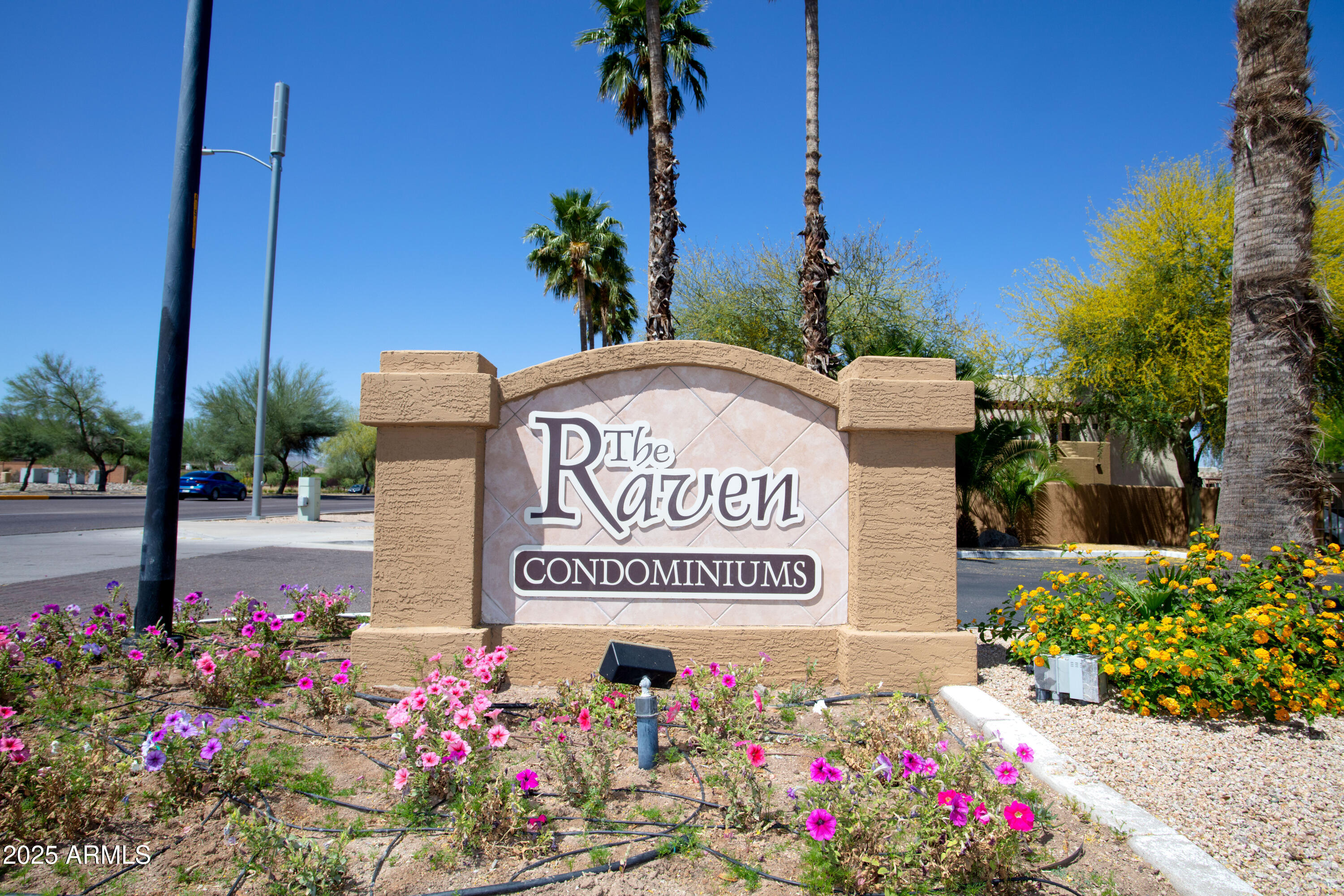 3434 East Baseline Road, Unit 331 Phoenix, AZ 85042 - Photo 1 of 37 a sign that is in front of flowers