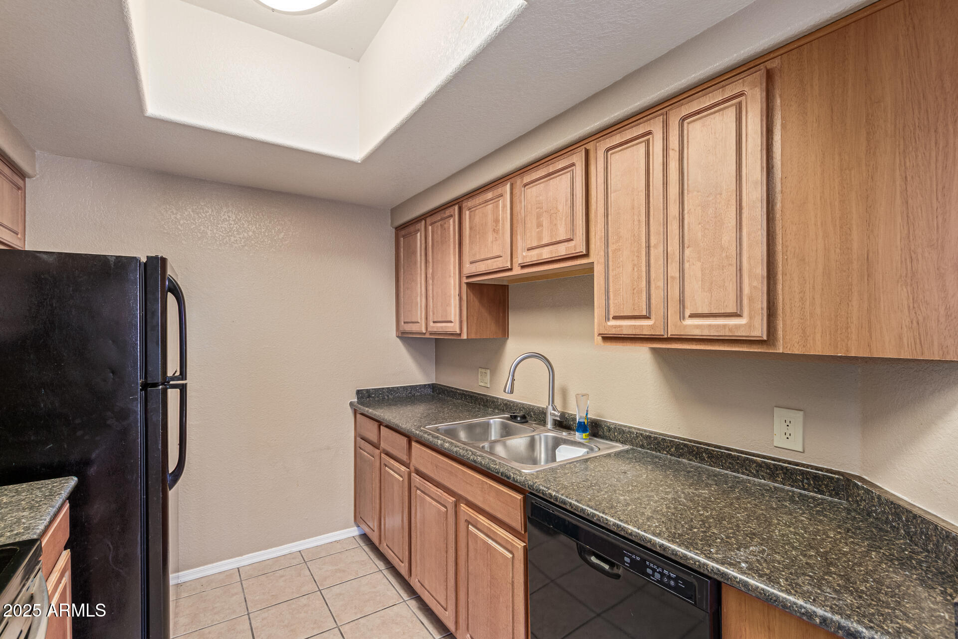 3434 East Baseline Road, Unit 331 Phoenix, AZ 85042 - Photo 12 of 37 a kitchen with stainless steel appliances granite countertop a sink stove and refrigerator