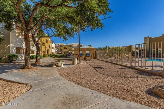 a view of a lake with couches and a fire pit