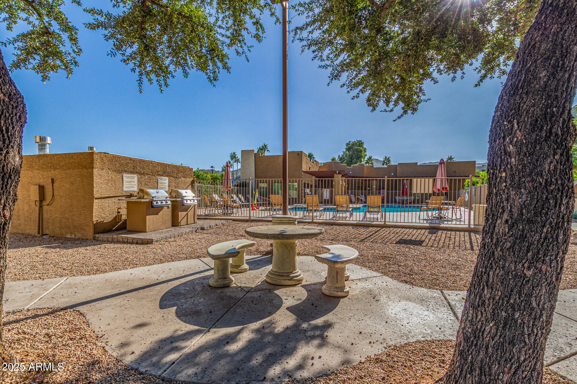 3434 East Baseline Road, Unit 331 Phoenix, AZ 85042 - Photo 20 of 37 a view of a lake with couches and a fire pit