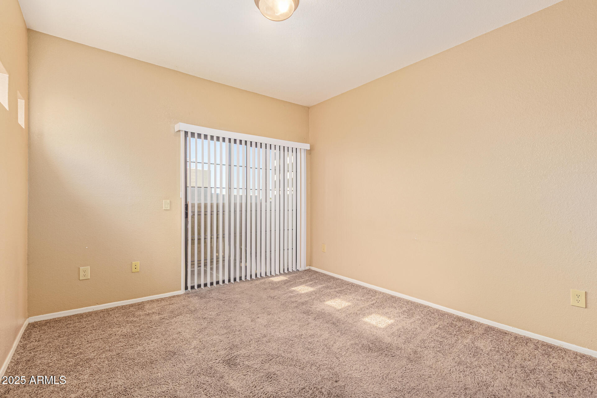 3434 East Baseline Road, Unit 331 Phoenix, AZ 85042 - Photo 5 of 37 an empty room with wooden floor and windows