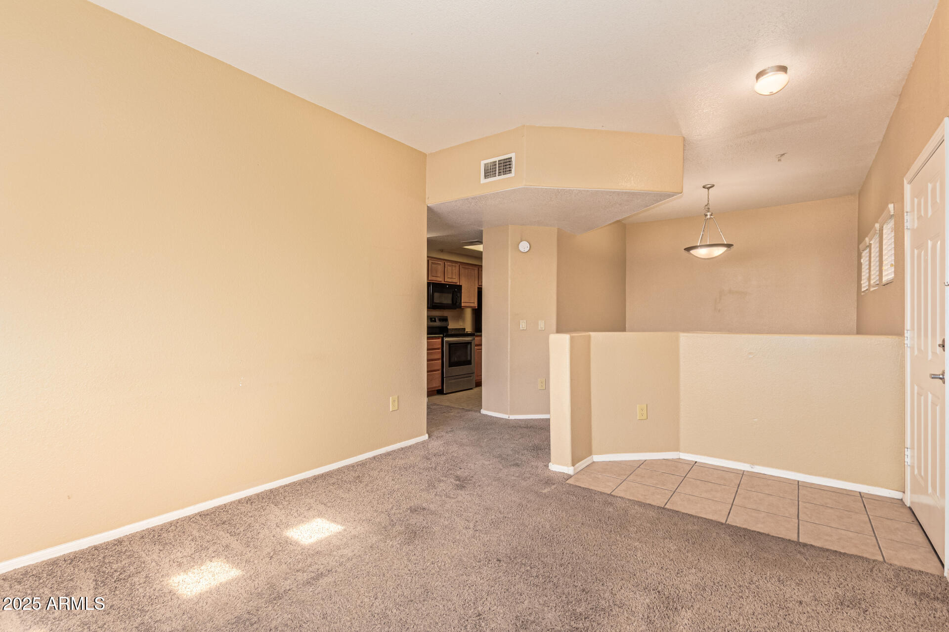 3434 East Baseline Road, Unit 331 Phoenix, AZ 85042 - Photo 6 of 37 en empty room with an entrance to other room