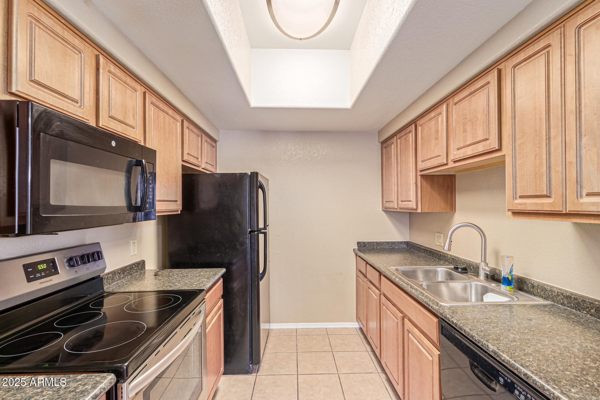 3434 East Baseline Road, Unit 331 Phoenix, AZ 85042 - Photo 10 of 37 a kitchen with stainless steel appliances granite countertop a sink stove and refrigerator