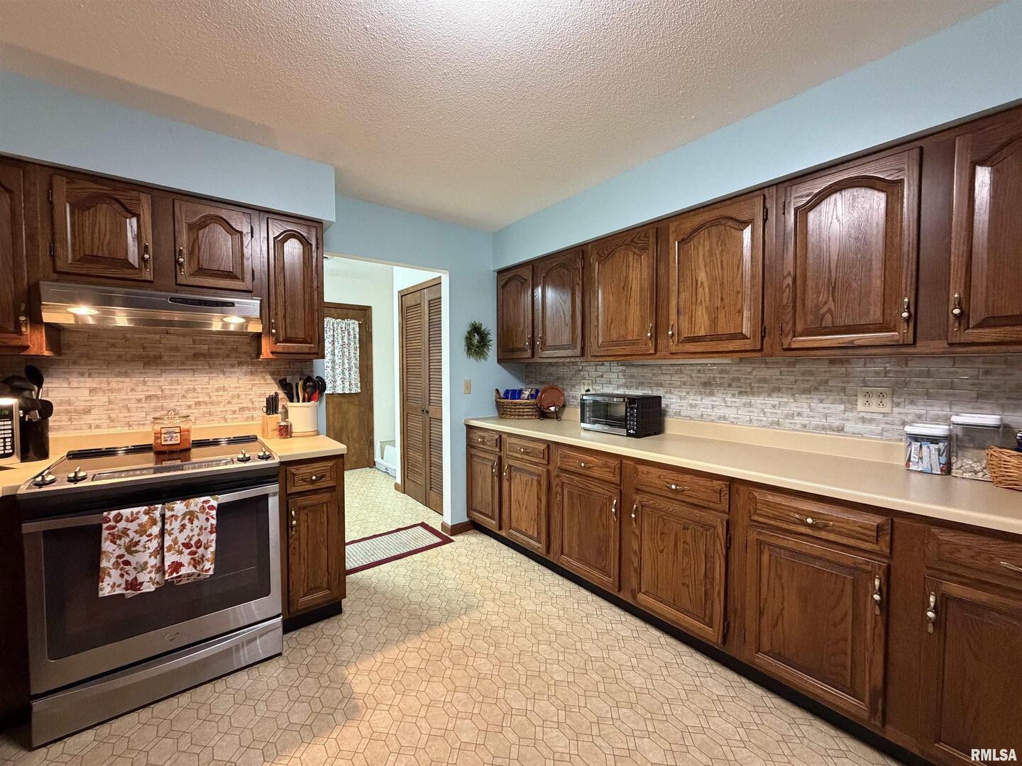 206 Daras Drive Carmi, IL 62821 - Photo 14 of 33 a kitchen with stainless steel appliances granite countertop wooden cabinets stove top oven and sink