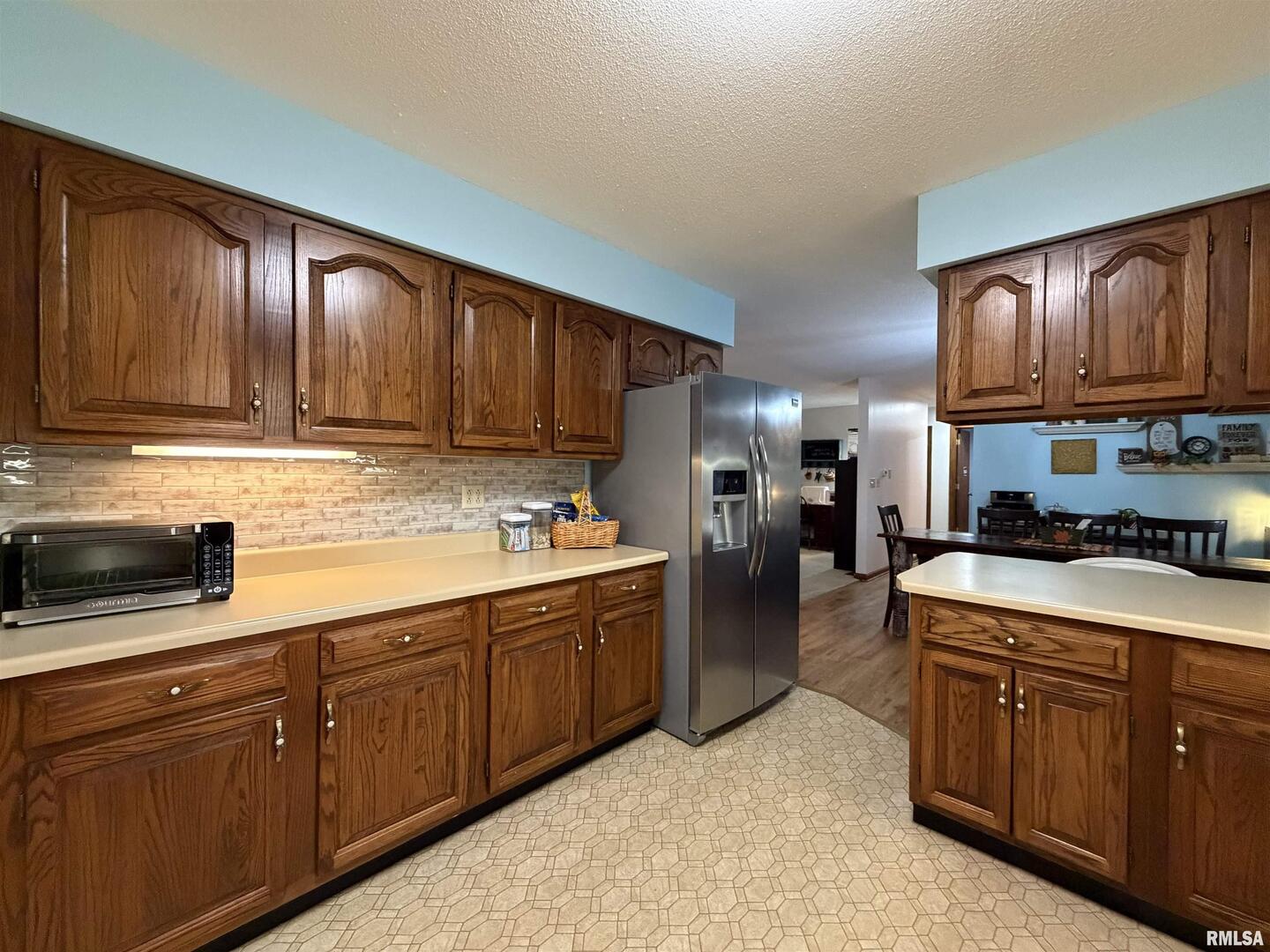 206 Daras Drive Carmi, IL 62821 - Photo 15 of 33 a kitchen with stainless steel appliances granite countertop wooden cabinets a stove top oven a sink and dishwasher