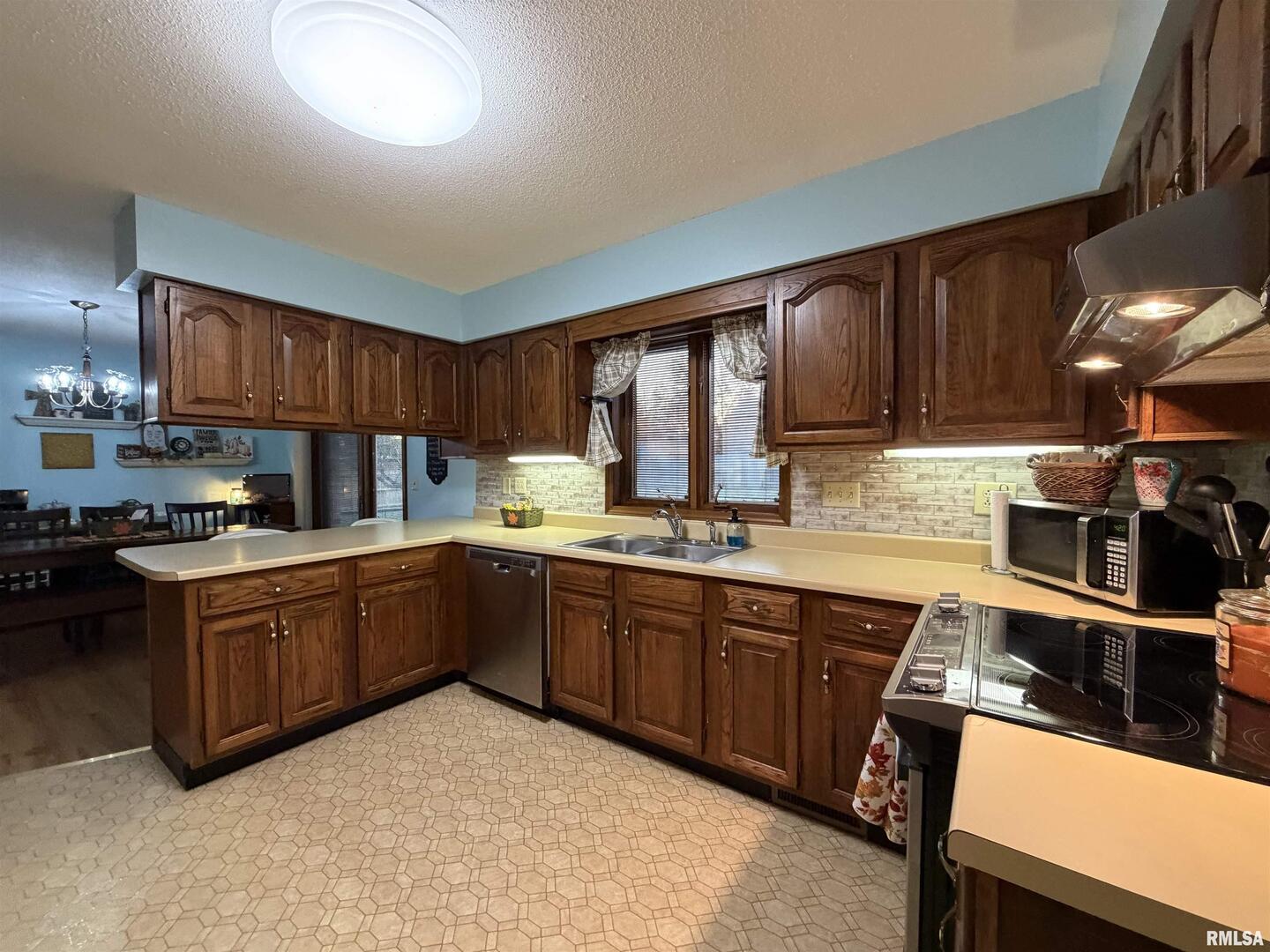 206 Daras Drive Carmi, IL 62821 - Photo 16 of 33 a kitchen with stainless steel appliances granite countertop wooden cabinets a stove top oven a sink and dishwasher