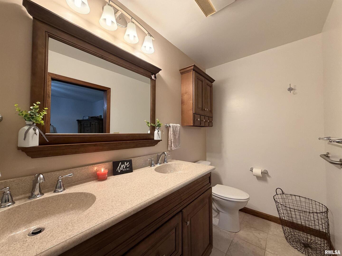 206 Daras Drive Carmi, IL 62821 - Photo 23 of 33 a bathroom with a double vanity sink toilet and a mirror
