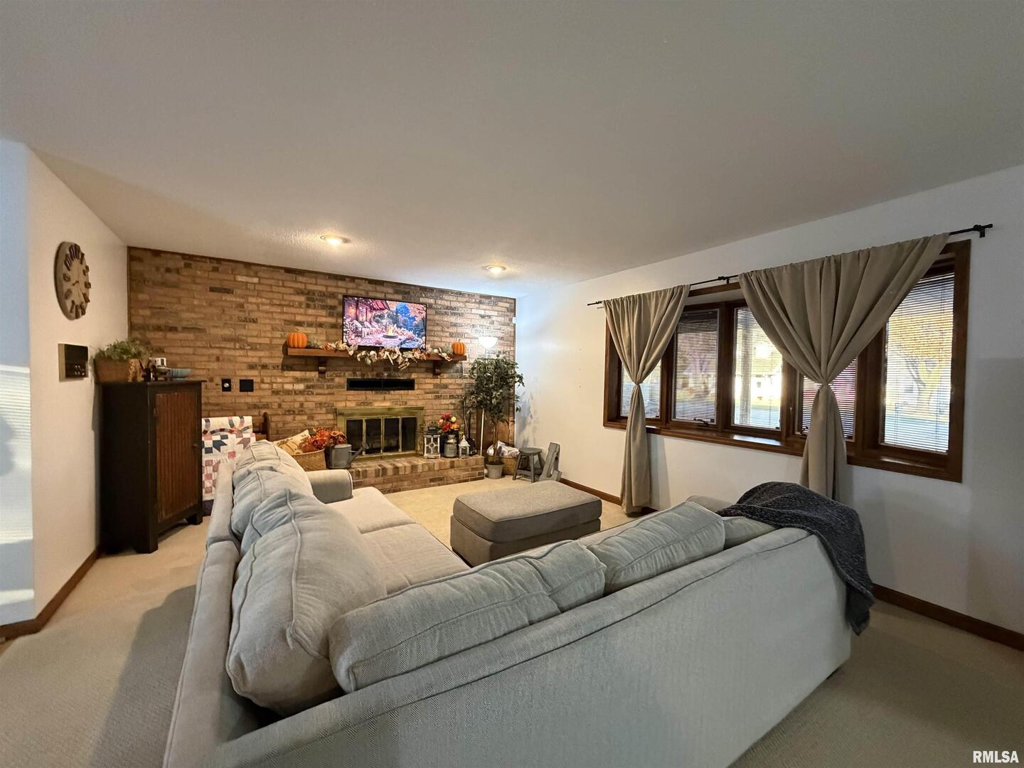 206 Daras Drive Carmi, IL 62821 - Photo 9 of 33 a living room with furniture a window and a flat screen tv