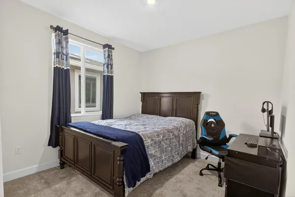 a spacious bedroom with a bed and a large window
