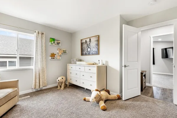 a bedroom with furniture and a window