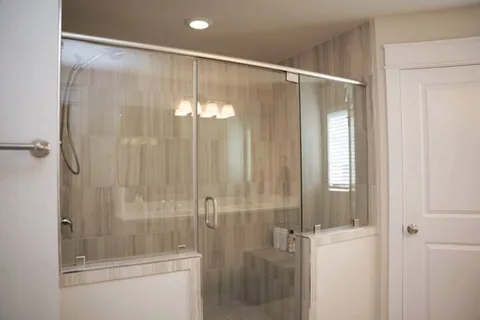 a bathroom with a glass shower door
