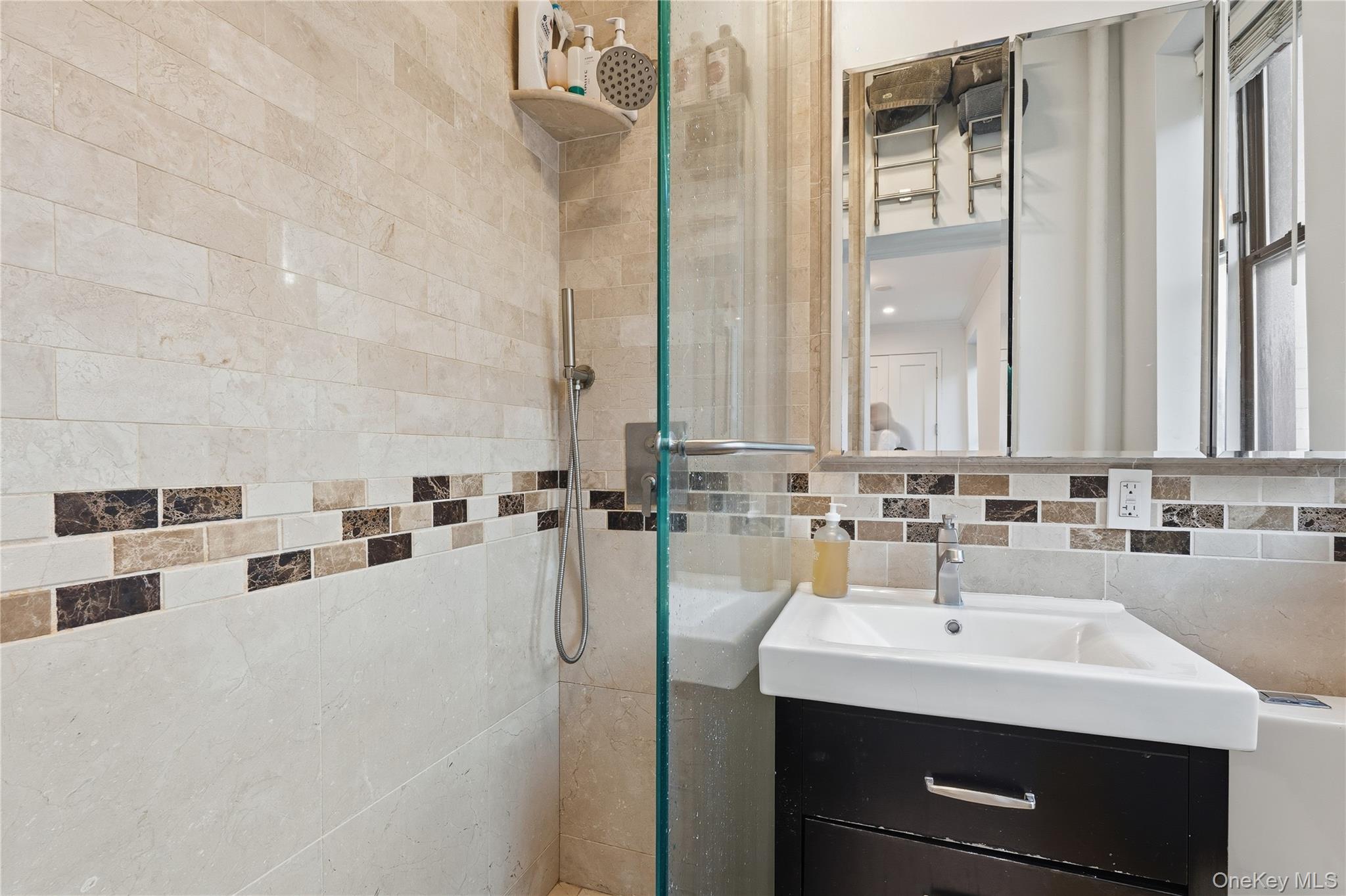 453 West 54th Street, Unit 4A Manhattan, NY 10019 - Photo 10 of 16 a bathroom with a sink double vanity and a mirror