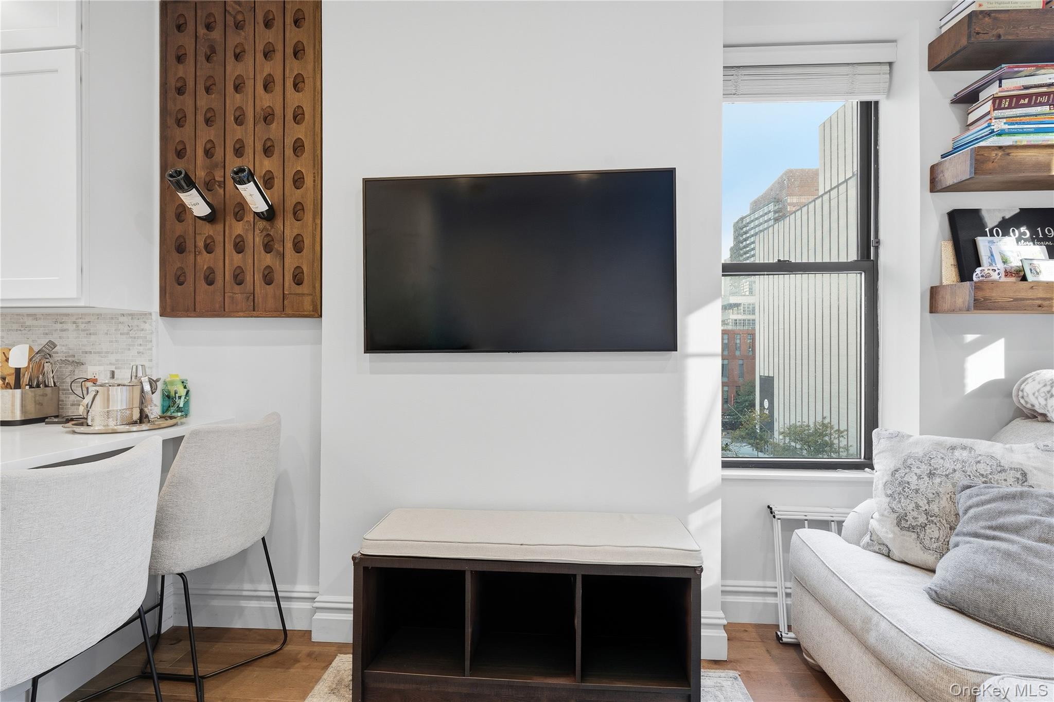 453 West 54th Street, Unit 4A Manhattan, NY 10019 - Photo 6 of 16 a living room with a couch and a flat screen tv