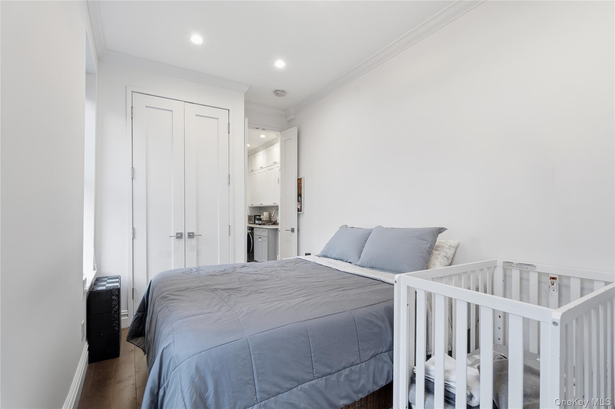 453 West 54th Street, Unit 4A Manhattan, NY 10019 - Photo 8 of 16 a bedroom with a bed with white walls