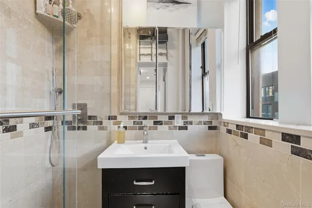 a bedroom with a bed with white walls