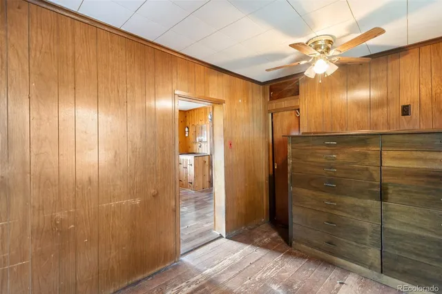 a view of a hallway with closet and wooden floor